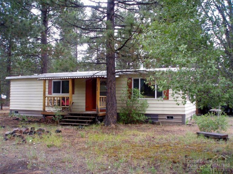 Property backs State land and a half mile from the state Park! Private fenced yard with Ponderosa Pines, circular driveway, RV parking and full hook-ups, certified wood stove, double carport, covered front and back porches, new laminate floor in kitchen and it comes furnished. The perfect get away from home!