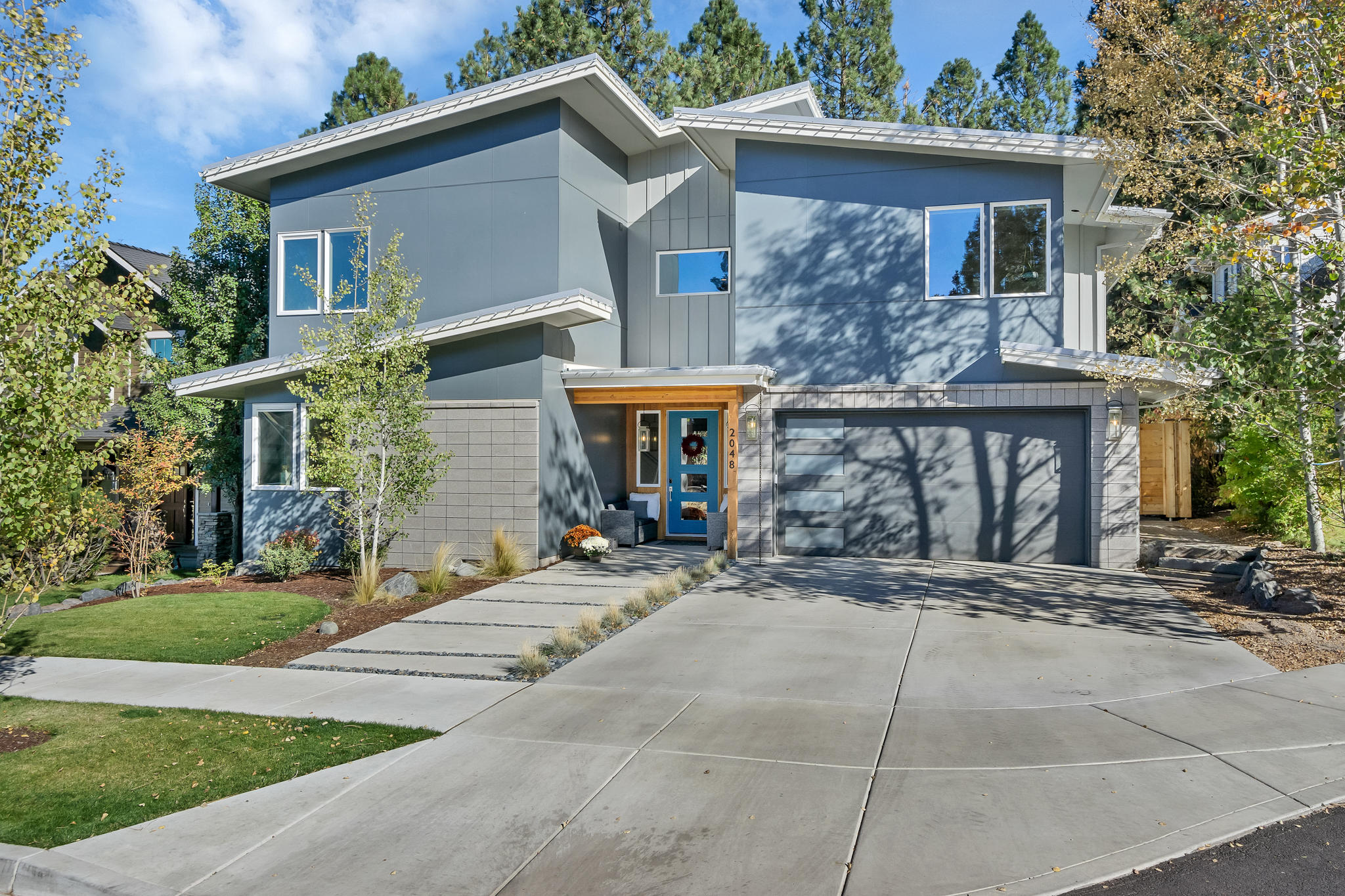 Built by Northwest Mountain Builders, this home offers nearly 3300 sq ft of thoughtfully crafted living space. This Northwest modern-inspired residence has an inviting and comfortable interior which blends seamlessly into the exterior living area. The great room concept layout includes a bonus space tucked behind the main living, as well as a full bedroom and bathroom.  Hickory hardwood flooring flows throughout the first floor and into the kitchen with expansive island, 48'' gas cooktop and walk-in pantry. The second level offers three additional guest bedrooms, two guest bathrooms and a private office. The primary bedroom is also located upstairs and features a spacious en suite bathroom with amazingly appointed shower and large walk-in closet. An enclosed outdoor living space, water feature, hot tub and native plant selections adorn the private, fully fenced backyard. Set in NW Bend, this stunner is minutes from downtown, dining, schools, trails and Shevlin Park.
