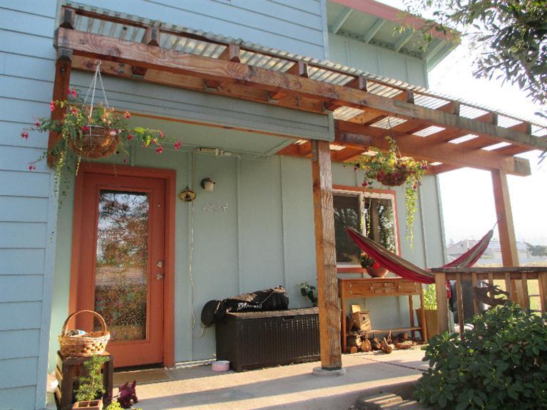 This is a truly special area in Ashland where community is strongly encouraged. Some of the amenities include lg. garden area, bike parking, play areas and play structure, ping pong table, gas fire pit and sitting areas. Also a common workshop and each homeowners own storage unit. The Community House is used for meetings, housing overnight guests, community meals and much more.This well designed 4 bdrm 2 bth 1640 Sq' home is energy efficient & features passive solar. Open floor plan on the main level w/ a wall of windows facing the back yard. Radiant cement floors heated by the instant gas hot water heater. Home is cooled with passive cooling. Rich cherry wood cabinets and stainless steel appliances in the kitchen. Large laundry room w/ample storage. One bedroom or office with slider to the back. Upstairs one large bedroom w/ double closets. The other 2 bedrooms each have unique features. One w/ a built in loft the other w/stairs leading to a secret place.