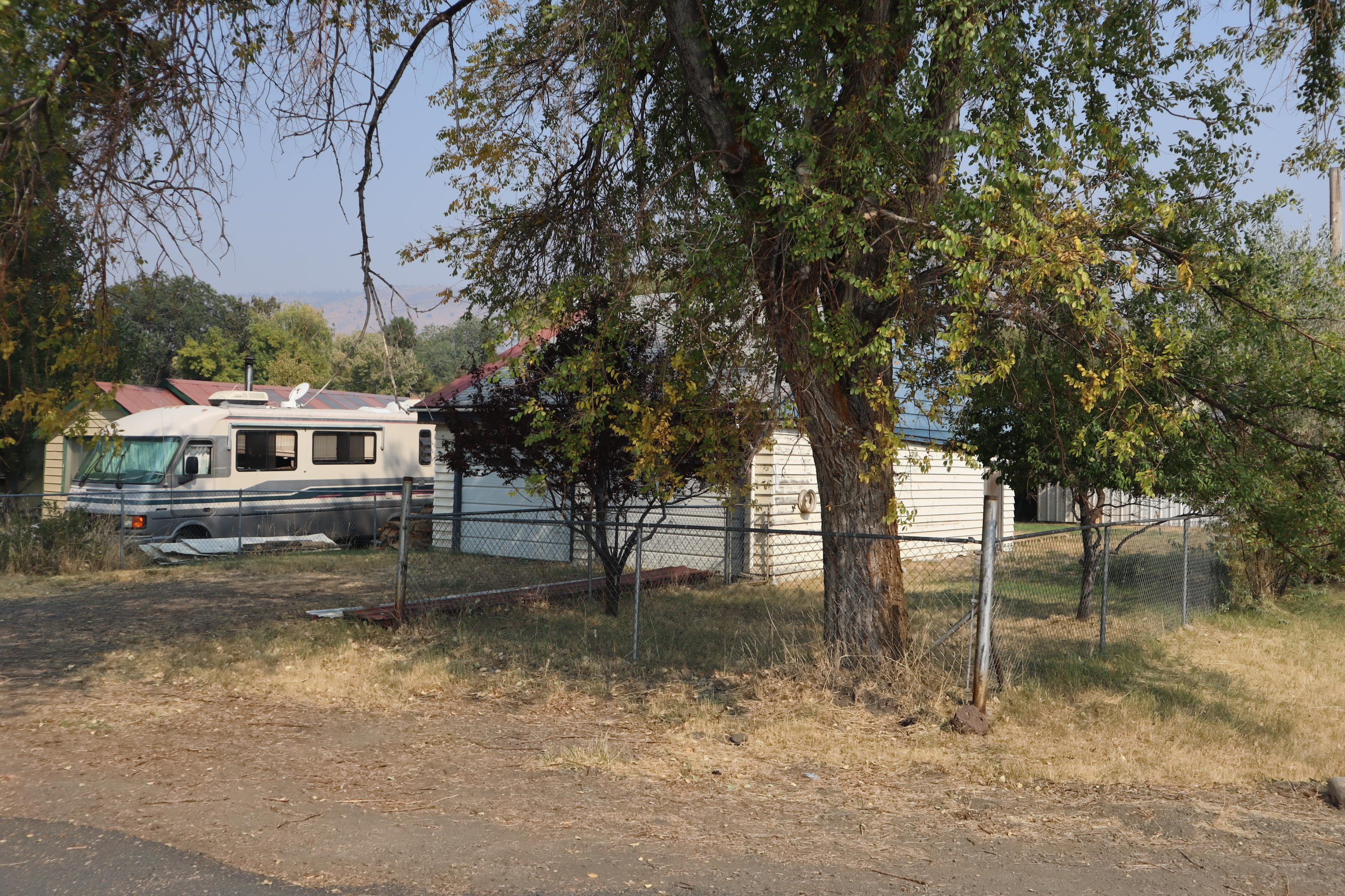 This is a unique lot in Lakeview OR, the property originally had a single-wide mobile home, garage, and icehouse. The Single-wide burned down but the garage and icehouse survived. The garage has structural issues, unrelated to the fire. The Icehouse has been modified and has a space that was once used as a darkroom for photo development. This property is being sold as-is.