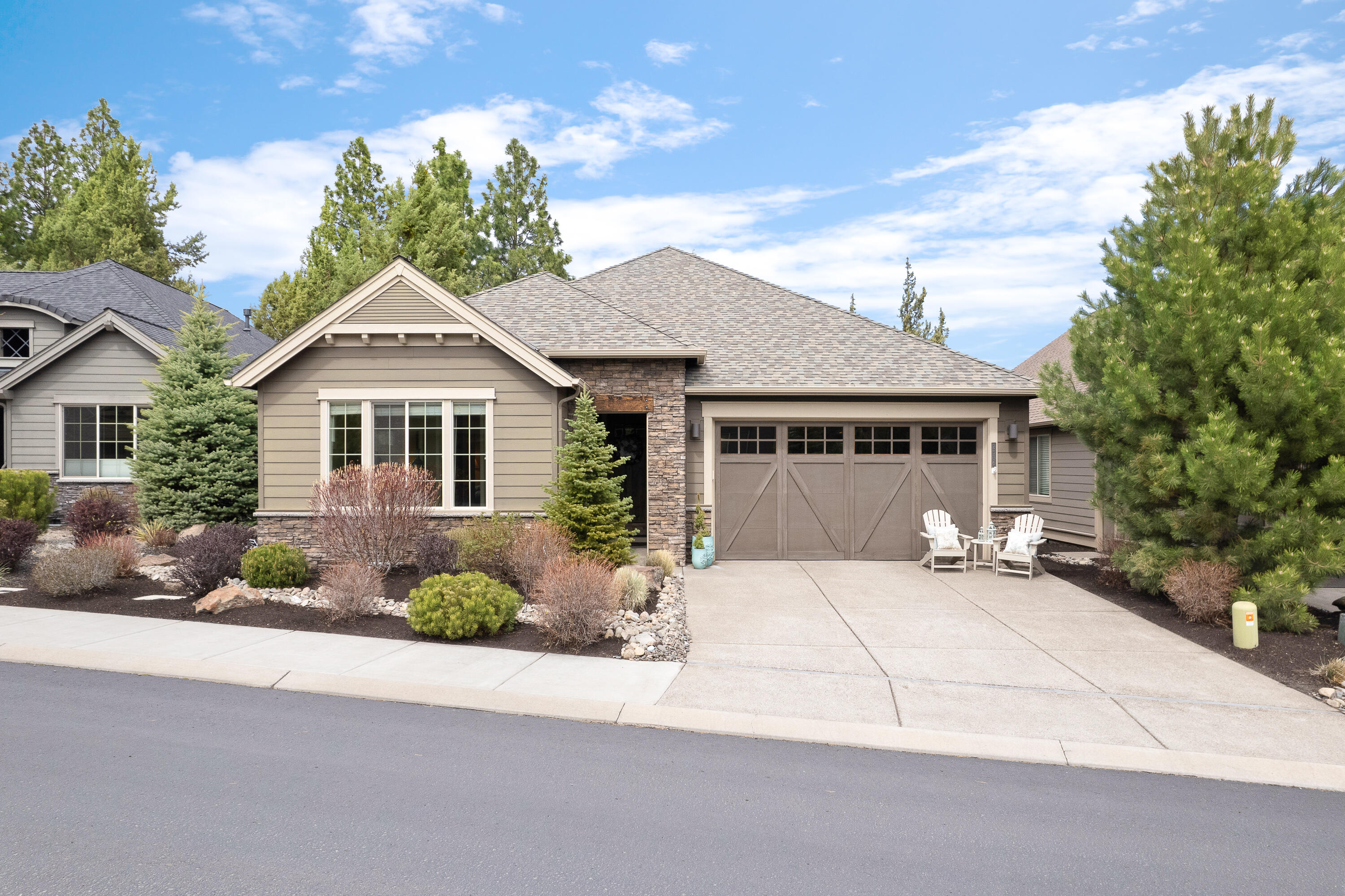 Stunning Northwest Pahlisch Built single level home with lovely views on Rivers Edge golf course. The open floorplan offers 3 bedrooms/2.5 bath, 2,105 sf and is conveniently nestled in Rivers Edge Village (golf membership optional) but close to the club house. Custom quality finishes throughout includes inviting entry into great room, large wood wrapped windows, abundance of natural light, quartz countertops, SS Jenn Aire appliances, soft close drawers, privacy glass, walk in pantry, engineered hardwoods, custom blinds, vaulted ceilings, stack stone gas fireplace with built in shelving, covered trex patio with paver walkway, wet bar with sink, laundry/mud room with bench and cabinets, and 2-car garage. Primary suite offers walk-in closet with custom built-in shelving, soaking tub, tiled shower, dual vanity sinks and access to patio area. Central A/C, 50-gallon water heater, two car attached garage with storage shelves. This west side home is a must see!