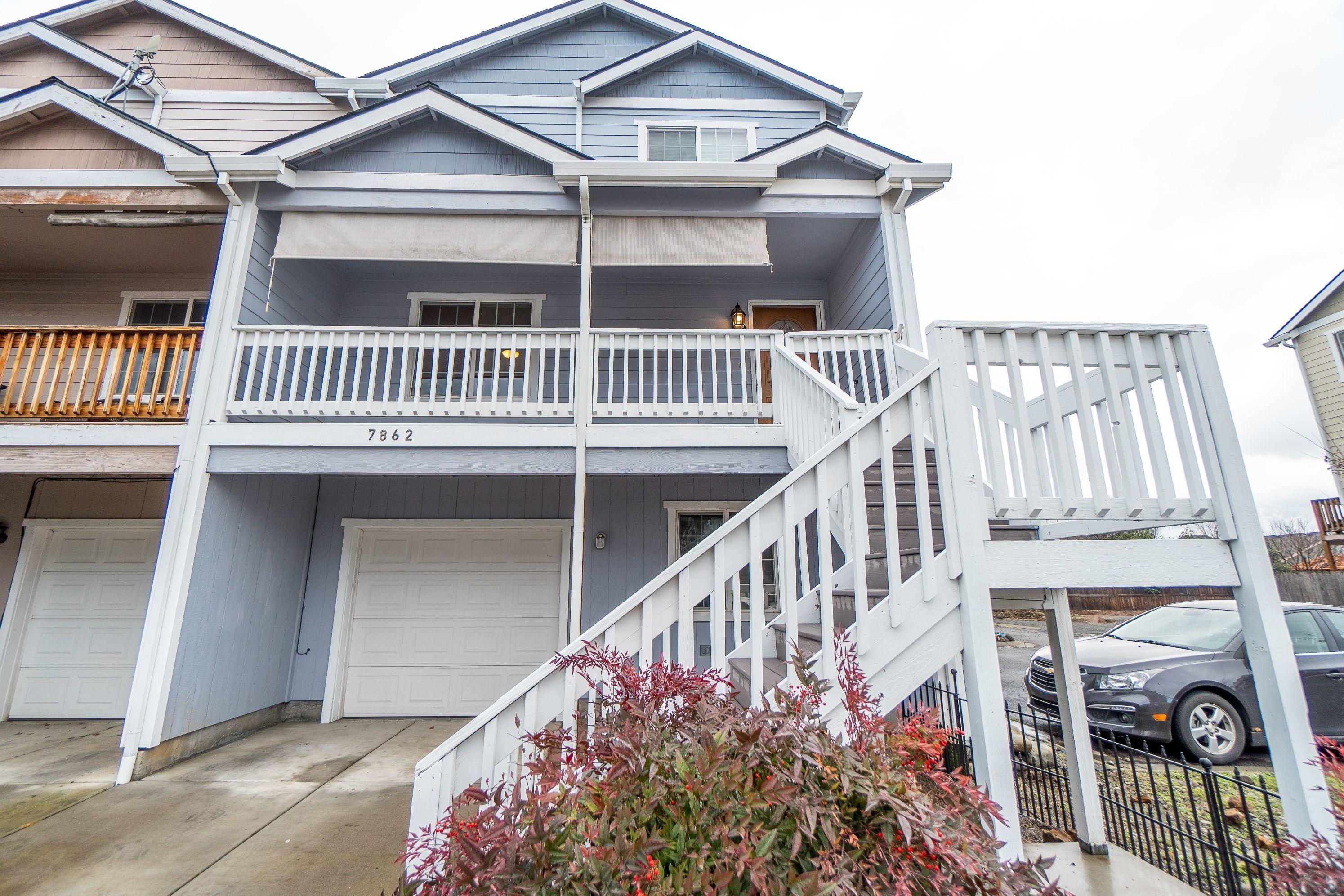 Better than NEW!!  All you have to do is move into this attractive and inviting END UNIT townhome that offers an open floor plan with an adjoining kitchen & family room. New flooring, kitchen counters and newer cooling unit.  New interior and exterior paint. Fantastic large second-story front deck with views , AND a rear second-story balcony with private patio below, and garage.  Two bedrooms on 3rd floor and 1 bedroom and bathroom on ground floor near the garage for extra privacy.