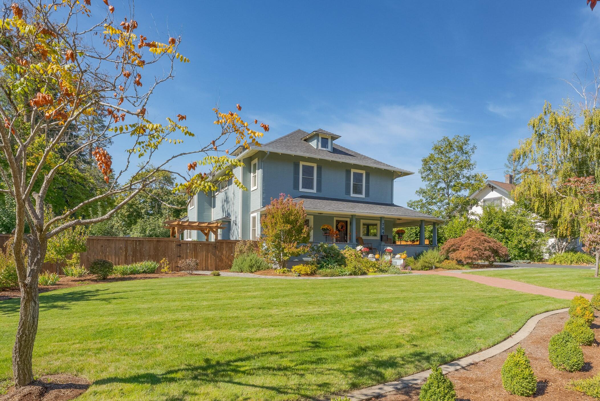 Traditional Beauty! Totally renovated, 4175 sq ft, & meticulously cared for inside & out. Set back, past a beautiful lawn that welcomes you to the lg front covered porch.  Specialized decorative tile entry, wood floors & cherry wainscotting welcome you to a time gone by.  Beautiful wood stairway to the 2nd story & wood framed vinyl windows thru-out for energy efficiency.  Formal living rm, oversized formal dining rm & a kitchen to match ANY kitchen in the valley! Lg eating island, tons of storage, walk-in pantry, Blue Star 8 burner gas stove, quartzite counters, wine fridge & dishwasher.  Light & bright w/rear covered porch for eating/entertaining & overlooks a small pond, gardens w/fruit trees, greenhouse & small shed.  Gas fireplace in living rm.  All bdms are upstairs (total 4 bdm, 3+ ba)  & the baths have been updated w/tile work, glass & new amenities. Basement for more storage or....? Gated, private yard, + office/media rm space over the lg attached garage & rm for RVs.
