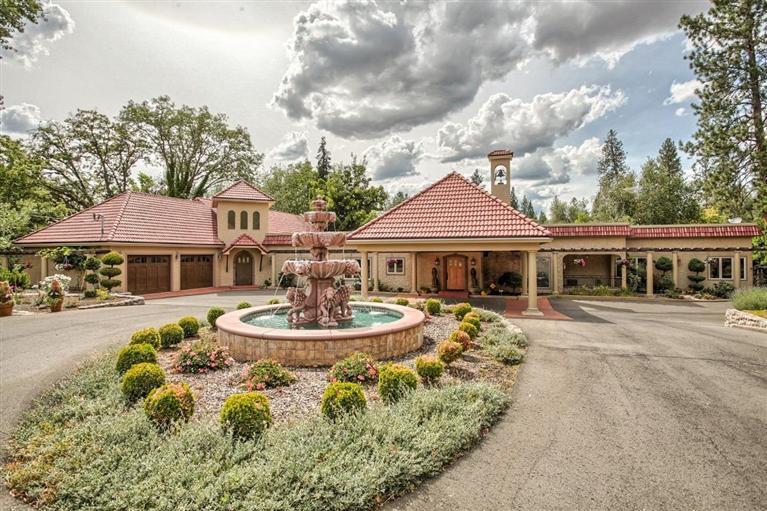Exquisite Tuscan style estate on the Rogue River! Tree lined driveway leads you to a courtyard with water feature & Porte-cochere to keep your guests out of the weather. Rogue River views greet you from the moment you walk in the front door. Large Chef's kitchen with custom cabinets, granite counters, commercial grade appliances & breakfast nook. Addt'l prep kitchen w/huge pantry off of large formal dining room that offers sweeping views of the river. Master suite w/river views, walk-in closet & master bath w/sauna, double vanity, large tiled shower. Enormous great room w/vaulted ceiling, built-ins & doors that lead to patio, is an amazing area for entertaining. Large patio overlooks the 265 feet of River frontage & gives you access to great fishing holes in the valley! 5 oversized fully finished garages w/heavy power & large doors easily accommodate boats, cars, rafts, etc. 2 detached storage buildings, plenty of paved parking. This is truly the place you have been dreaming of!