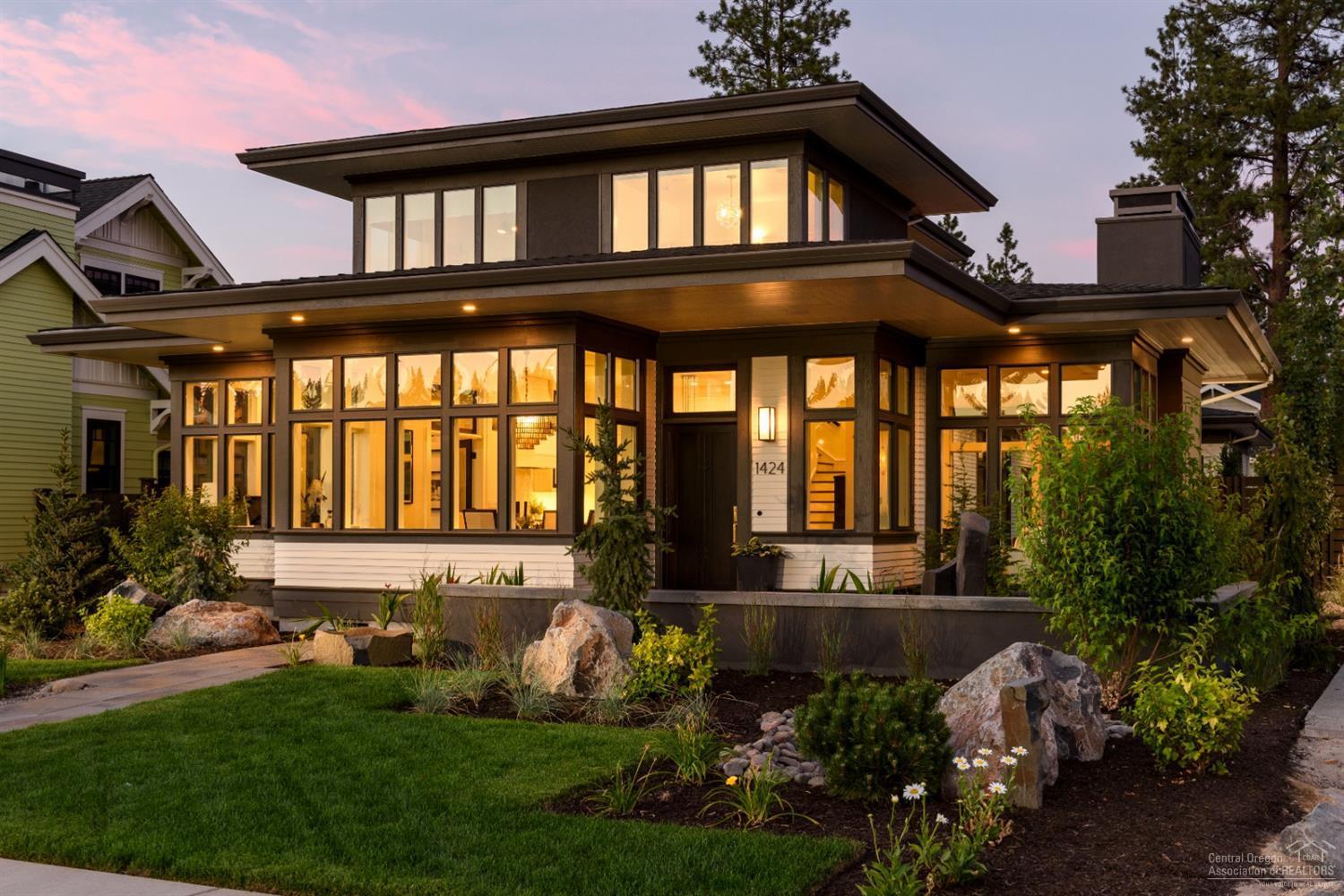 Overlooking Discovery Park and lake, this award-winning prairie style home defines NorthWest Crossing living. Your guests will be impressed by this home's fine hardwoods, solid surface countertops, custom cabinets and built-ins, as well as its designer lighting fixtures. Enjoy a custom floorplan, designed and built by Salvesen Homes, featuring chef's kitchen and master suite on the main level and a bright, naturally-lit bonus room on the upper level. Outside, find a large patio with firepit and creatively designed landscape. This home features a 3-car garage, including custom built-ins. The 3rd bay features 2 overhead doors opposite one another creating a spacious breezeway when both opened.