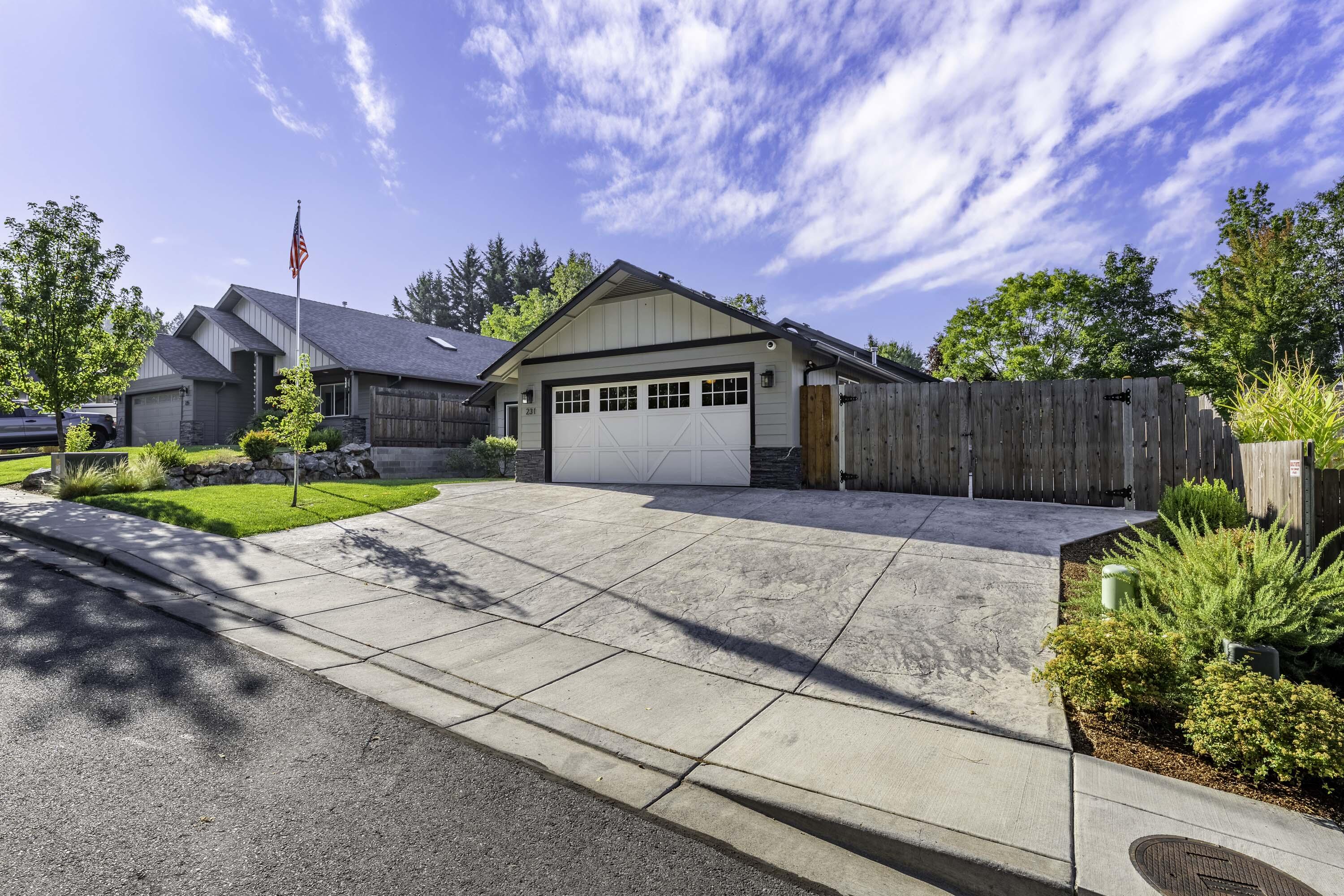 Just a few minutes from Hospital, Grants Pass Golf Course, and shopping, you will find 231 Sand Canyon Lane. The 2021 built home is 1884 sq ft, Single Level, and offers 3 bedrooms & 2 bathrooms. Home features granite counter tops, concrete siding, stainless appliances, gas fireplace with natural stone, superior alder cabinets, food pantry, vaulted ceilings in living and primary bedroom, and RV Parking with dump and electrical hook ups. The backyard is private, well manicured, has room for garden beds, and has a covered concrete patio to lounge and BBQ on. Short cul-de-sac streets, lends to low traffic location. Definitely a home to tour, see the quality and convenience of the home and its location.