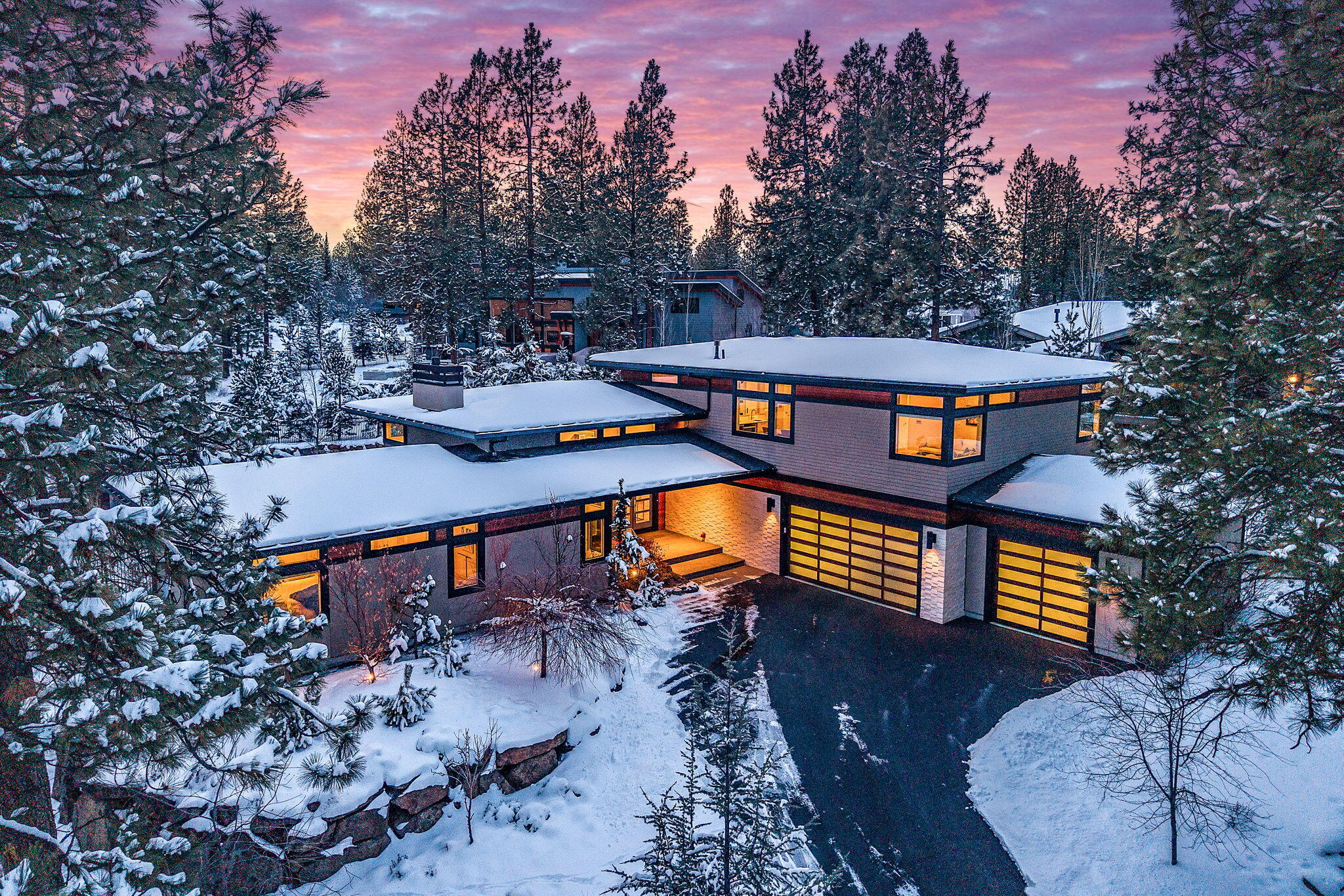 Discover contemporary elegance in this stunning Shevlin Ridge residence, masterfully designed by renowned architect Brandon Olin. Set on a beautifully landscaped .32-acre lot, this architectural gem blends sophistication with natural serenity. The striking exterior features clear cedar siding with island stone accents, hinting at the refined design within. Inside, expansive open living spaces are bathed in natural light from custom transom windows. DuChateau oiled white oak flooring, bespoke lighting, and a dramatic limestone fireplace create understated luxury. The gourmet kitchen boasts Wolf appliances, a Sub-Zero refrigerator, sleek European cabinetry, and a walnut-accented island perfect for gathering. Thoughtful details abound—custom walnut built-ins, abundant storage, and an oversized 1,260 sq ft three-car garage with a dedicated dog-washing station. Multiple outdoor entertaining areas include lush landscaping, a cozy firepit, tranquil water features, a built-in BBQ. and more.