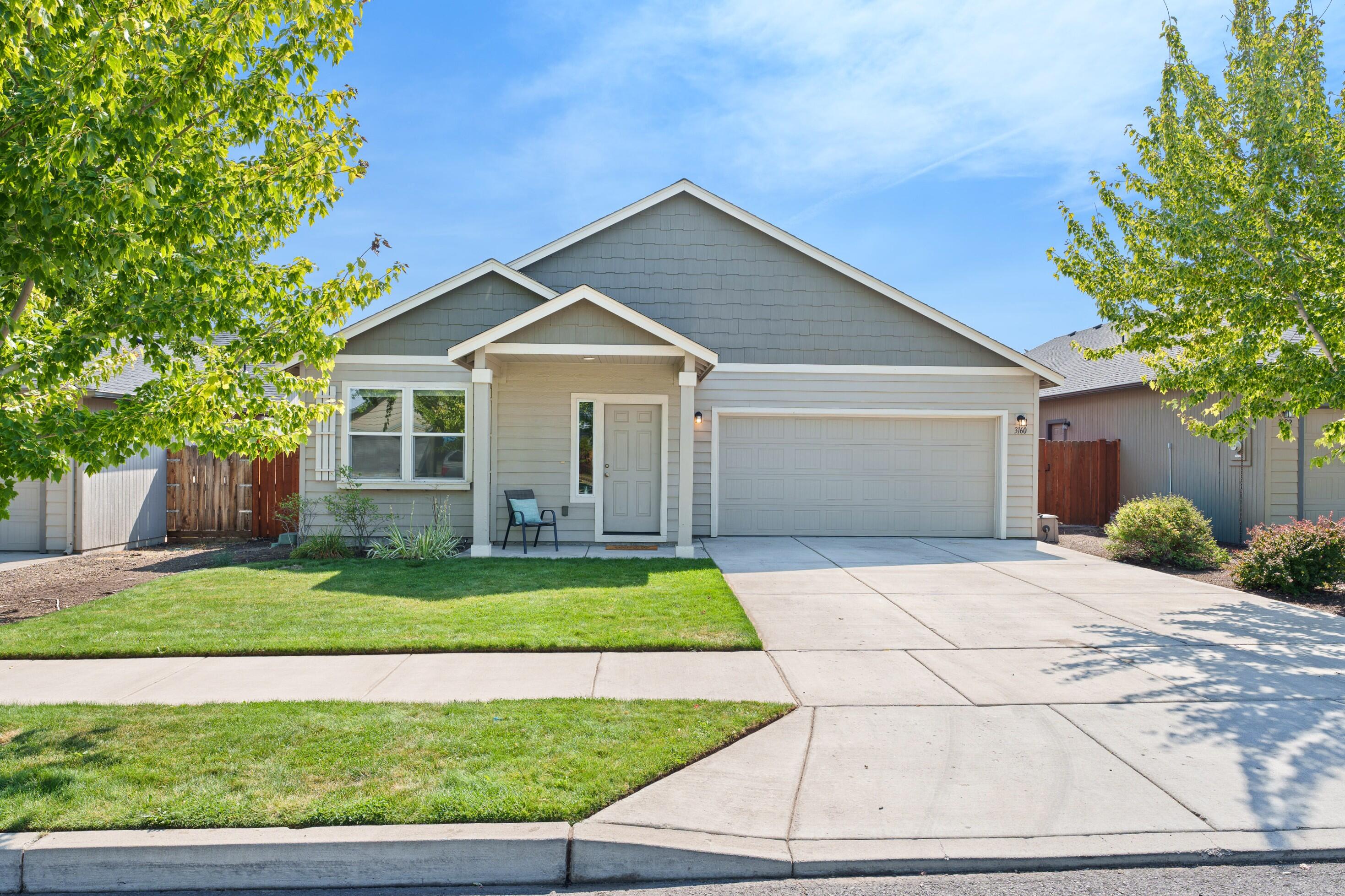 SW Redmond SINGLE LEVEL home in Carly Meadows. Light and bright open floor plan. Kitchen with breakfast bar and pantry. Primary bedroom suite with a walk-in closet, dual sinks and a tub/shower. Large fenced back yard with a lush lawn and room for a garden and hot tub. Forced air heating and air-conditioning. 2-car garage. One block from Vern Patrick Elementary and close to shopping.
