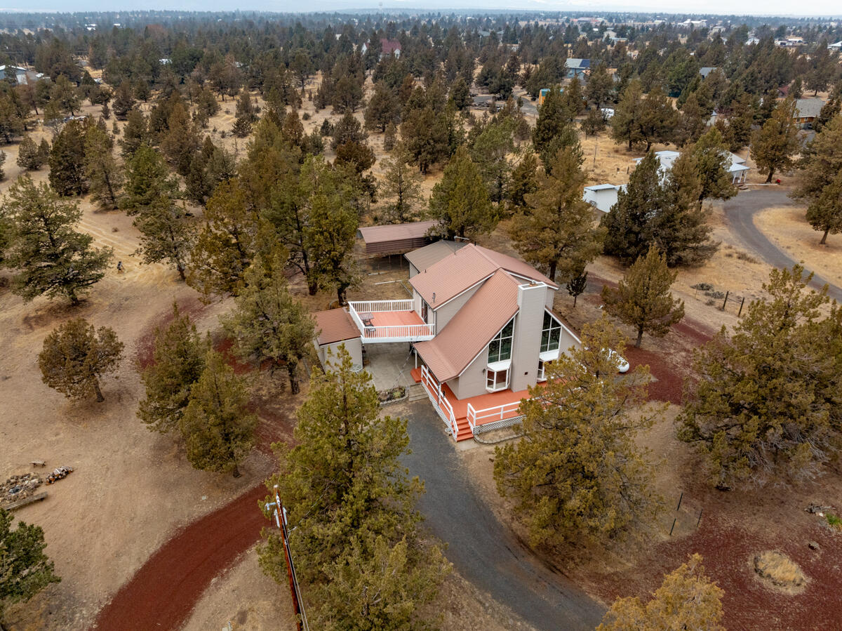 Discover your personal sanctuary in this charming chalet, where warmth and nature converge. Featuring big pinewood ceilings and a vaulted great room, this home exudes an inviting atmosphere perfect for relaxation. Cozy up by the warm propane fireplace and let the beauty of the big stained-glass windows fill your space with color and light.
This unique property offers an open loft-style bedroom upstairs and a big second story deck to enjoy an intimate getaway and mountain views. Step outside to enjoy the expansive decks, where you can soak in the privacy wildlife on your 3 acres. The property also includes a double car garage, covered RV storage, and additional storage buildings, making it perfect for outdoor enthusiasts. Surrounded by wildlife and nestled in a quiet area, this chalet offers the privacy you desire while still being close to nature's beauty. Don't miss this opportunity for your dream escape!