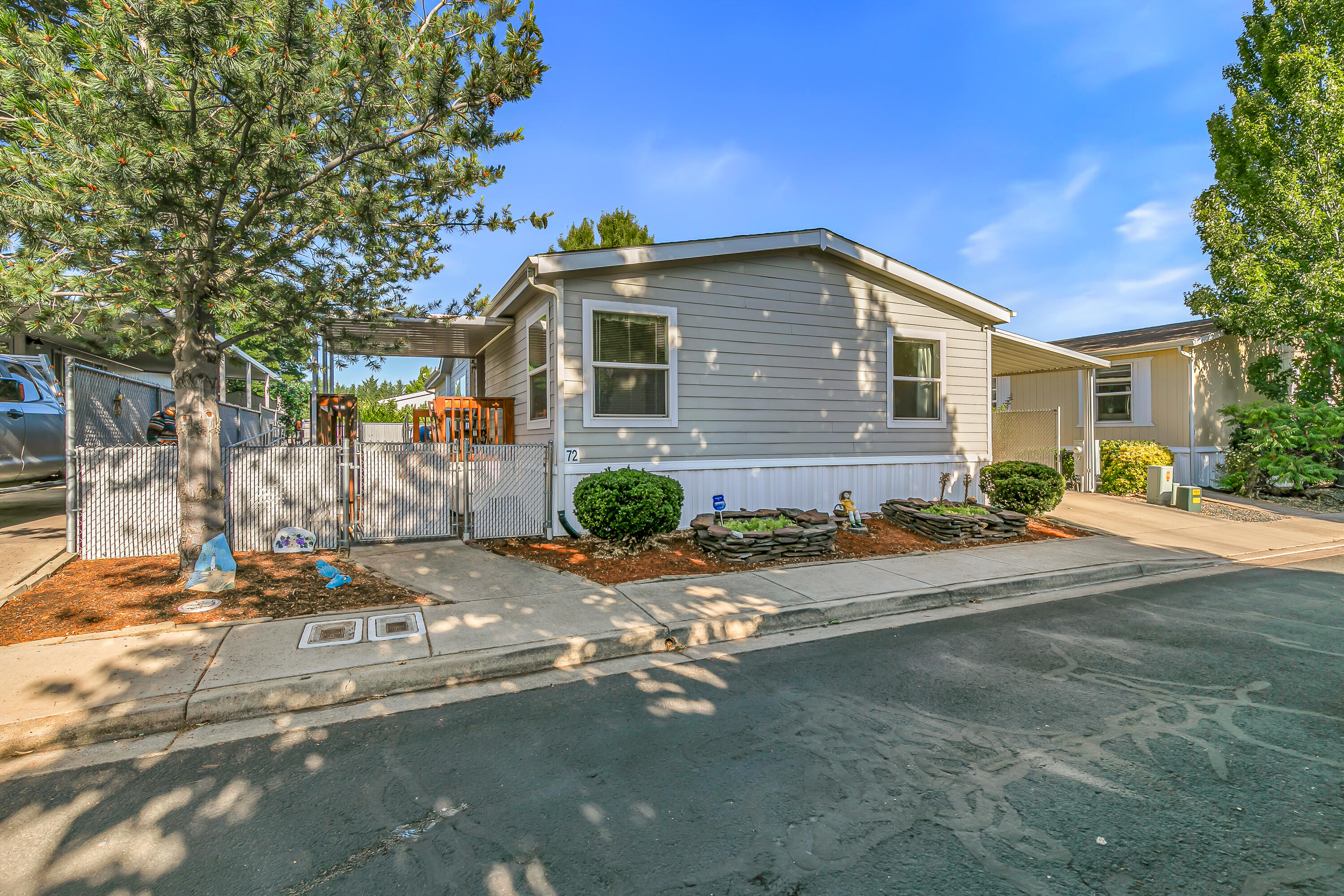 Location, location, location! Looking for a low maintenance move-in ready home in an all-ages manufactured home park? If so, this is the one for you! This handicap accessible home (built by Northwest Home Builders) features 3 bedrooms, 2 bathrooms, 1620 sq ft, open floor plan, spacious kitchen (all appliances included), large primary bedroom w/ walk-in closet and dual vanities in the bathroom, vaulted ceilings, multiple solar tubes, 3 detached sheds, attached carport, & much more! Over the last few years, the owners have replaced the HVAC system and installed a high efficiency hot water heater. Yard is spacious and offers privacy w/ a large patch of turf. Space rent is $1050 per month as well. Couldn't build this property for $135,000, so if you're looking for a bang for your buck deal, contact your agent today for a personal tour, before it's too late!