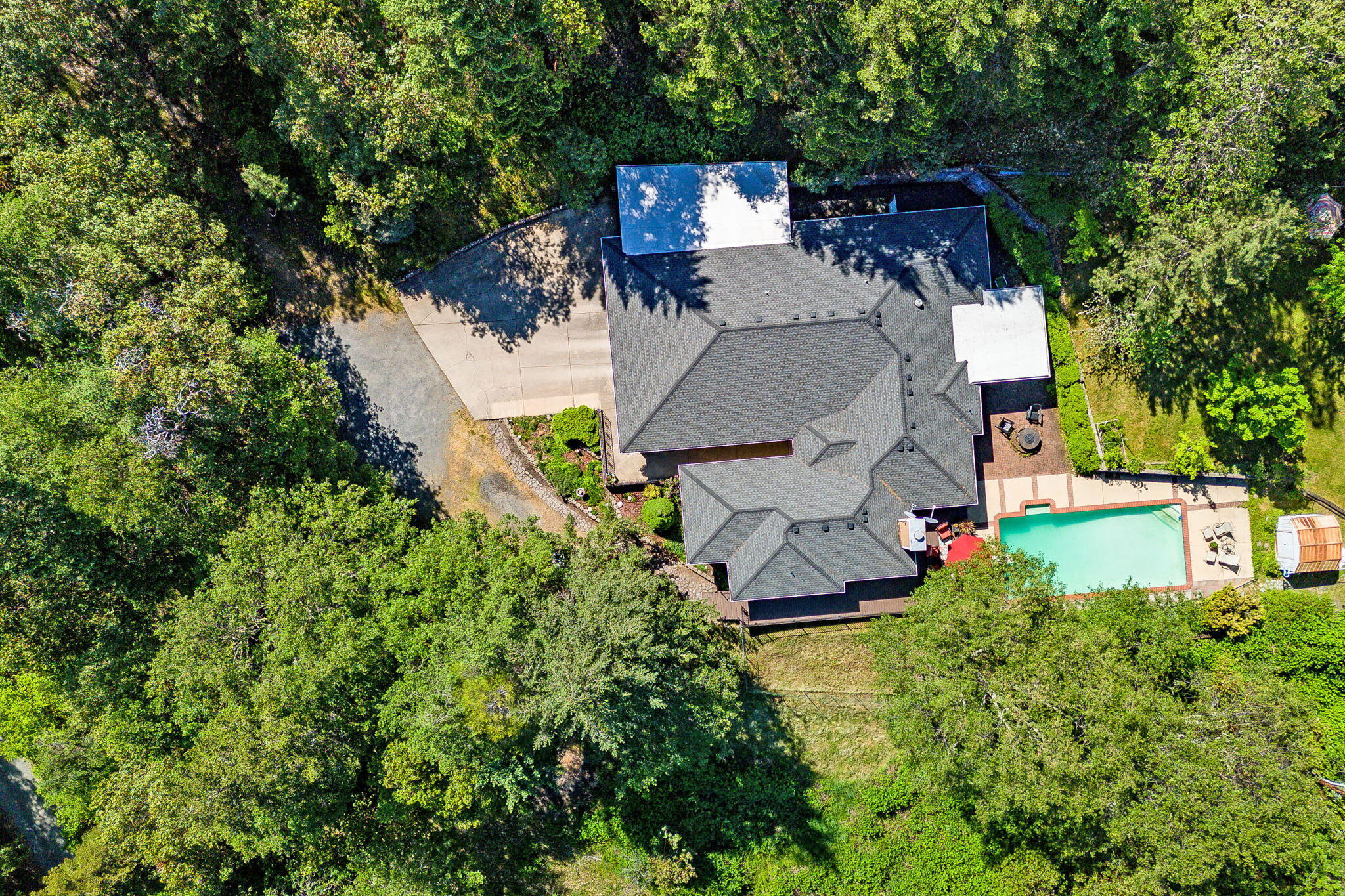 Price Improvement!  20 acres located in SW Medford just outside of Jacksonville. Tranquil setting offers the perfect balance between seclusion and convenience. Split floor plan with 4 bedrooms, 2 bathrooms, beautiful wood floors, kitchen has granite countertops, large island, cook top, double wall oven and ample storage. Living room with wood burning fireplace, cozy family room, formal dining area plus separate eating area. Enjoy the private deck looking over the pool and beautiful forest or relax in the enclosed sun room. In-ground pool, 3 sheds, 3-car garage and a carport...Room for all your toys!  New Roof in 2011, Heat Pump in 2014, Composite deck in 2018 and pool pump motor in 2022. Whether you're seeking a peaceful sanctuary or a place to entertain family and friends, this exceptional property offers it all.