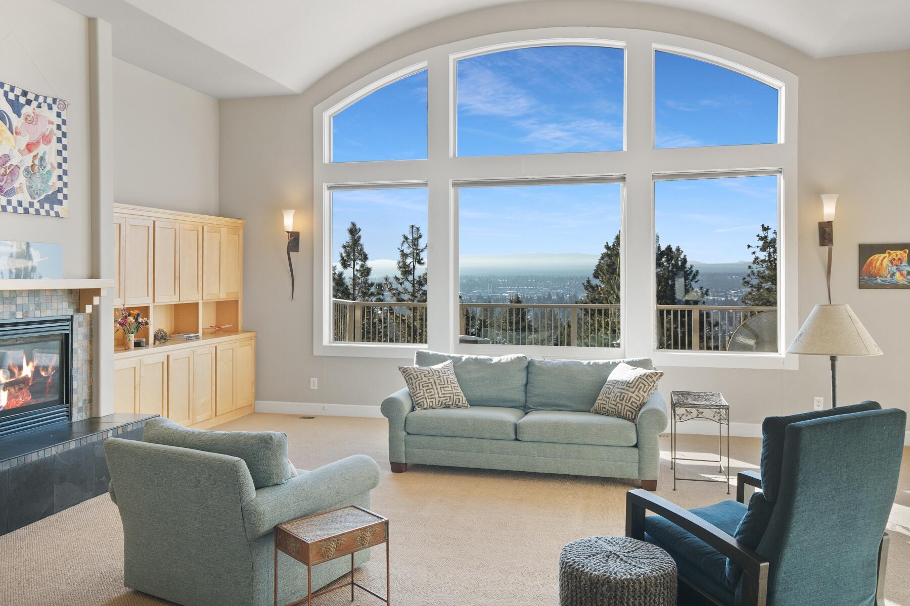 Perched on the sun-drenched side of Awbrey Butte in the coveted Hillside Park neighborhood, this residence boasts views of the iconic Old Mill smokestacks. Only a block from Hillside Park and ideally situated to take advantage of the Newport Commercial District. The main level hosts the primary suite with a highly functional layout, including the living, dining, and kitchen areas. The home features several spaces for gathering, along with ample bedrooms and an office for quieter times. The lower level includes a generous family/rec room, perfect for a media room. The recently stained deck provides an ideal viewing spot for the 4th of July fireworks launched from Pilot Butte. In the winter months, you can track the weather coming in from the west over the Cascades. The oversized windows in the living room invite you to pause and take in the beauty of the outdoors. Convenience to town, recreational activities, and amenities completes this home, blending comfort and accessibility.