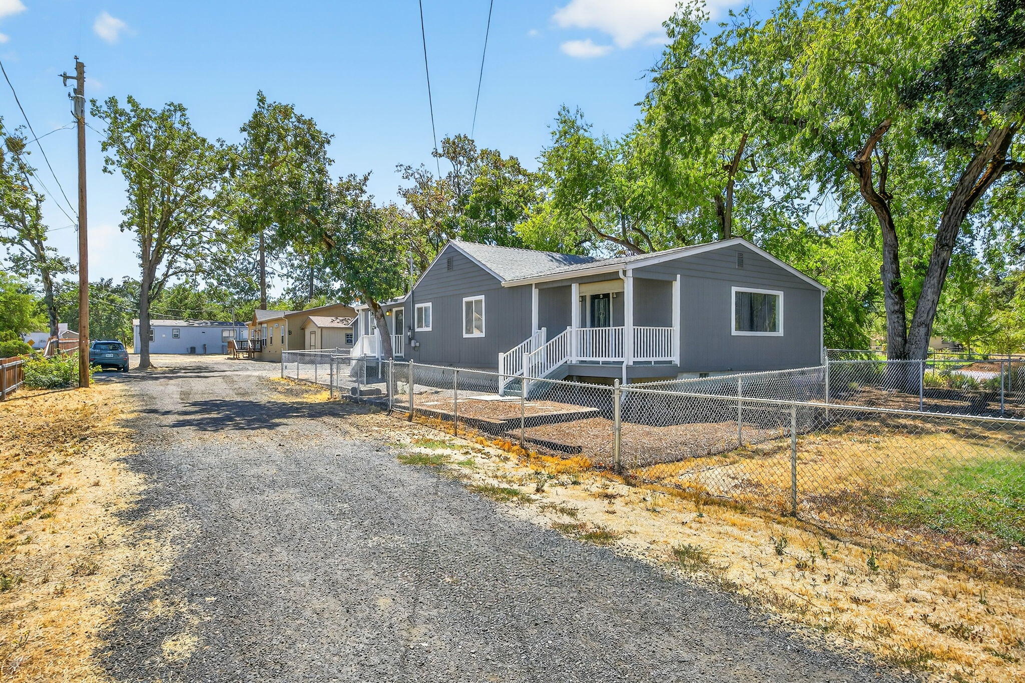 OWNER FINANCE TERMS AVAILABLE! Competitive interest rate offered w/ flexible terms & savings including NO LENDER POINTS OR FEES! This property offers a positive cash flow investment or multi-family living opportunity w/ 3 newer homes on one lot! Unit A is a frame construction 1,608 sf home rebuilt in 2014 w/ 3 beds & 2 baths & a new HVAC in 2022. Unit B is a 1,456 sf manufactured home built in 2016 w/ 3 beds & 2 baths; new flring installed. Unit C is an 840 sf manufactured home built in 2014 which offers 2 beds & 2 baths. There are 2 wells on the property; one serves Unit A, & the other serves Units B & C. Unit A has a large matching shed & a well house w/ extra rm for storage. Unit B has 2 matching sheds & a front deck perfect for entertaining. Unit C has a matching shed & greenhouse. Each unit has a private fenced yard & a large level undeveloped area at the rear of the property offers room for RV parking, shop space, or more.