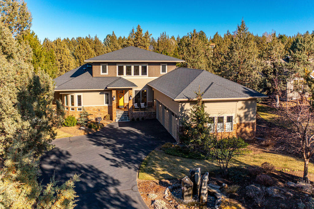 A true Eagle Crest gem! This custom home offers over 3,500 square feet of beautiful finishes and materials including bamboo flooring and cabinetry, floor to ceiling windows, skylights, granite countertops, high end appliances and so much more. Don't miss the attached features sheet for more details and expansive list of upgrades. The main level has an open concept and features a luxurious master suite, bright front office, laundry room and a junior suite. Upstairs is a spacious loft with a gas fireplace and two more bedrooms both offering en suite bathrooms and walk in closets. Additionally the home has an oversized three-car garage, central vacuum, and a whole house sound system, just to name a few. The park-like backyard backs to the 15th fairway of the Resort Course but still offers tons of privacy with tall, mature trees. All that Central Oregon has to offer is at your fingertips in Eagle Crest Resort with its convenient location between Bend, Redmond and Sisters. It's a must see!