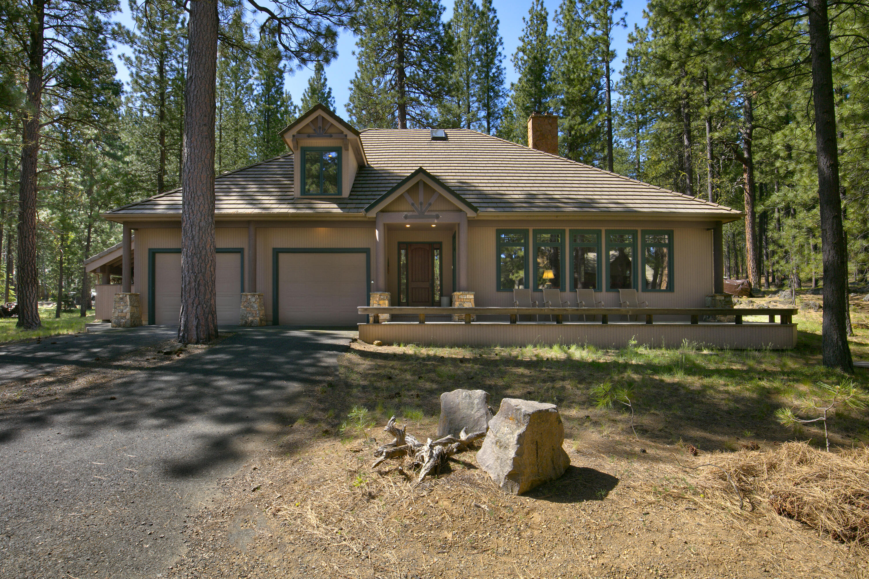 Special property alert in Black Butte Ranch! Ideally located near the Glaze Meadow Rec Center and golf course, this charming home offers the perfect blend of rustic elegance and modern comfort. The spacious great room features soaring vaulted ceilings, stunning interior timber framing, and a cozy wood-burning fireplace. The chef's kitchen opens to a dedicated dining area, ideal for gathering with family and friends. The ground floor primary suite includes an ensuite bath and walk-in closet. Upstairs, you'll find three additional bedrooms—two connected by a Jack-and-Jill bath. An attached two-car garage provides ample storage, while the welcoming front and back porches invite you to relax and savor the serene, natural beauty of Black Butte Ranch. A truly special retreat!