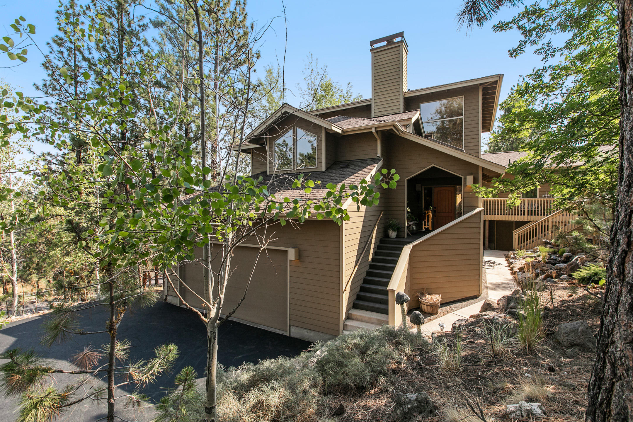 Come and enjoy this serene home on 1.45 acres! Super peaceful oasis with wind blowing through the aspens and just steps to the river trail. This 4 bedroom home has so many tasteful features and recent upgrades. Kitchen and bathrooms have custom tile and cabinets, enjoy the new water feature and new paver seating area in the private backyard, and house has an abundance of storage. The master bedroom is upstairs with lots of windows where you look out onto the treetops. The master bath has a walk in shower, heated floor, double vanity and walk in closet. The other bedrooms are on the lower level with a full bathroom, laundry, and dark room. There is an artists studio w/separate entrance and full bathroom which could be used as another bedroom, office, bonus room, mother in law suite, etc. The home has a living room with a fireplace plus a family room with a cozy woodstove. There are two huge decks on the home to enjoy the outdoor serenity! This is a true hidden gem on the West side!