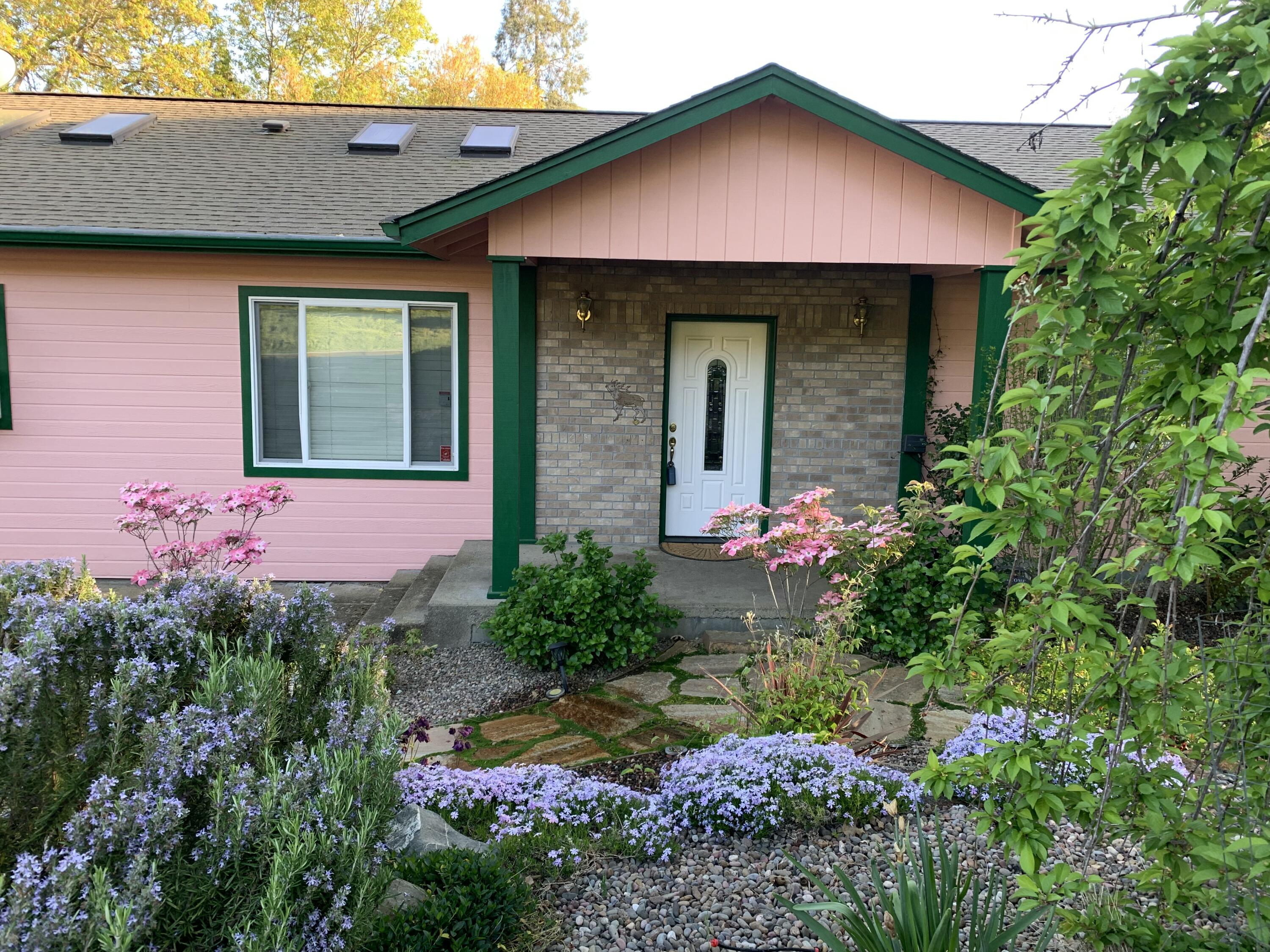 Come check out this warm and inviting home with great curb appeal. Spacious Home with vaulted ceilings, sky lights and numerous windows give this home an abundance of natural light which flows through from room to room in this lovely home.  Large kitchen with 5 burner gas stove with 2 ovens, huge pantry, garden window above sink, eat in area connected to family room. There is a dining room too.  Large deck off family room conveniently located for entertaining includes a gazebo with a ceiling fan, power and water.  Living room with recessed lighting and a view of the mountains.   Guest bath is a tub/shower combo.  Laundry is located in hall and includes washer and dryer.  Primary is spacious with recessed lighting, access to its own deck through a sliding glass door, walk-in closet and shower.  2 more bedrooms are nicely sized.  Front yard is landscaped, low maintenance and has a drip system.  Garage is heated has shelves and 2 workbenches.
