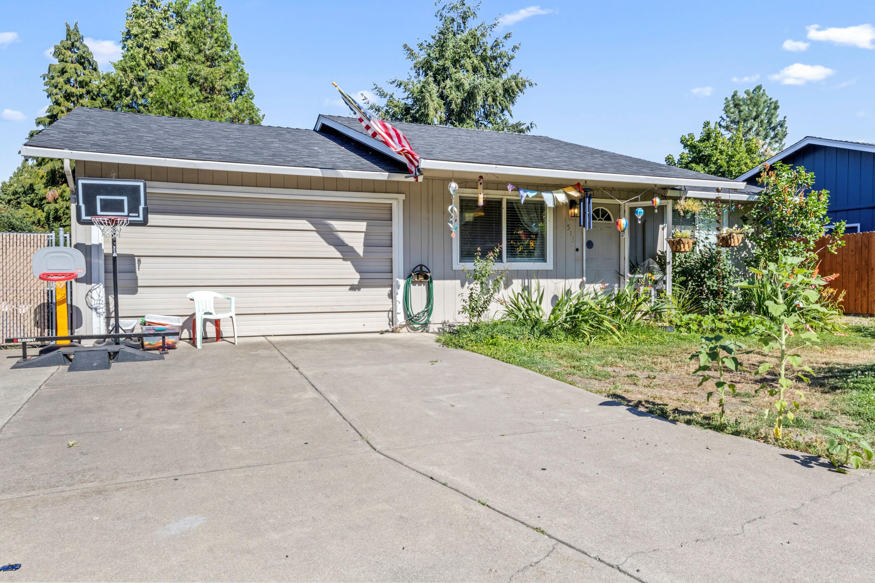 Great starter home! This charming and cozy 3-bedroom home is located in a nice Talent neighborhood, conveniently close to parks, schools, and shopping centers. It features an attached garage and plenty of driveway and on street parking. Inside you'll find an abundance of natural light in the kitchen and dining area, thanks to a lovely, large sliding glass door that not only brightens the room, but opens up to a patio in the fenced backyard. There is plenty of outdoor space to relax or entertain! The home has been lovingly cared for. Call for a tour today!