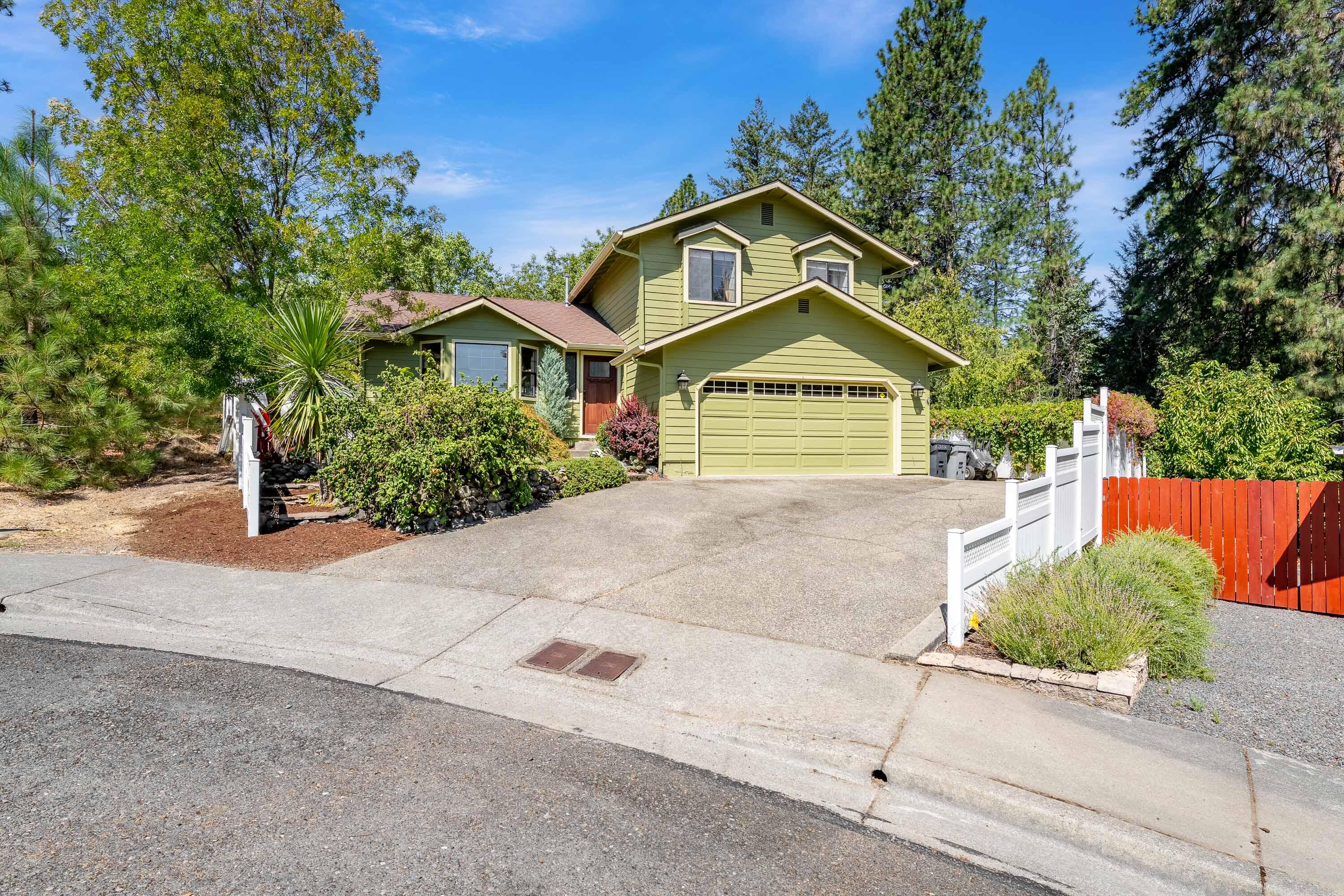 Immaculate NW Grants Pass Home at the End of a Cul-de-Sac. Tucked away in a desirable NW neighborhood, this beautifully maintained 3 bedroom, 2.5 bath home offers space, comfort, and style. Step into the inviting living room with vaulted ceilings or relax in the separate family room—perfect for entertaining or everyday living. The heart of the home is the fully remodeled kitchen, featuring custom cabinetry, granite countertops, tile backsplash, and stainless steel appliances. The primary suite is a true retreat with his & her closets, a bonus space ideal for a nursery or home office, private balcony, and a spa-like remodeled ensuite complete with dual vanities and a tile walk-in shower.
Outside, enjoy thoughtfully designed spaces including multiple patios and decks, raised garden beds with a shed, and a hot tub for unwinding at the end of the day. Located on a quiet cul-de-sac, this home combines privacy with convenience in one of Grants Pass's most sought-after areas. Take a look!