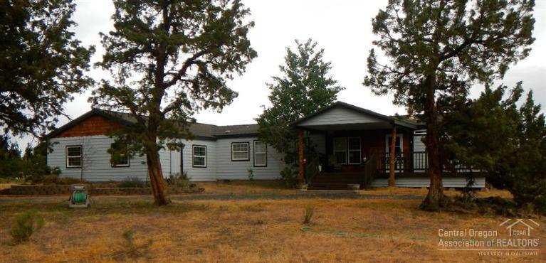 This private haven has everything you need. Lovely home features vaulted ceilings, skylights, ceiling fans, wood stove and hardwood flooring. An attached triple garage gives you space for your toys. A small storage shed is on the side.