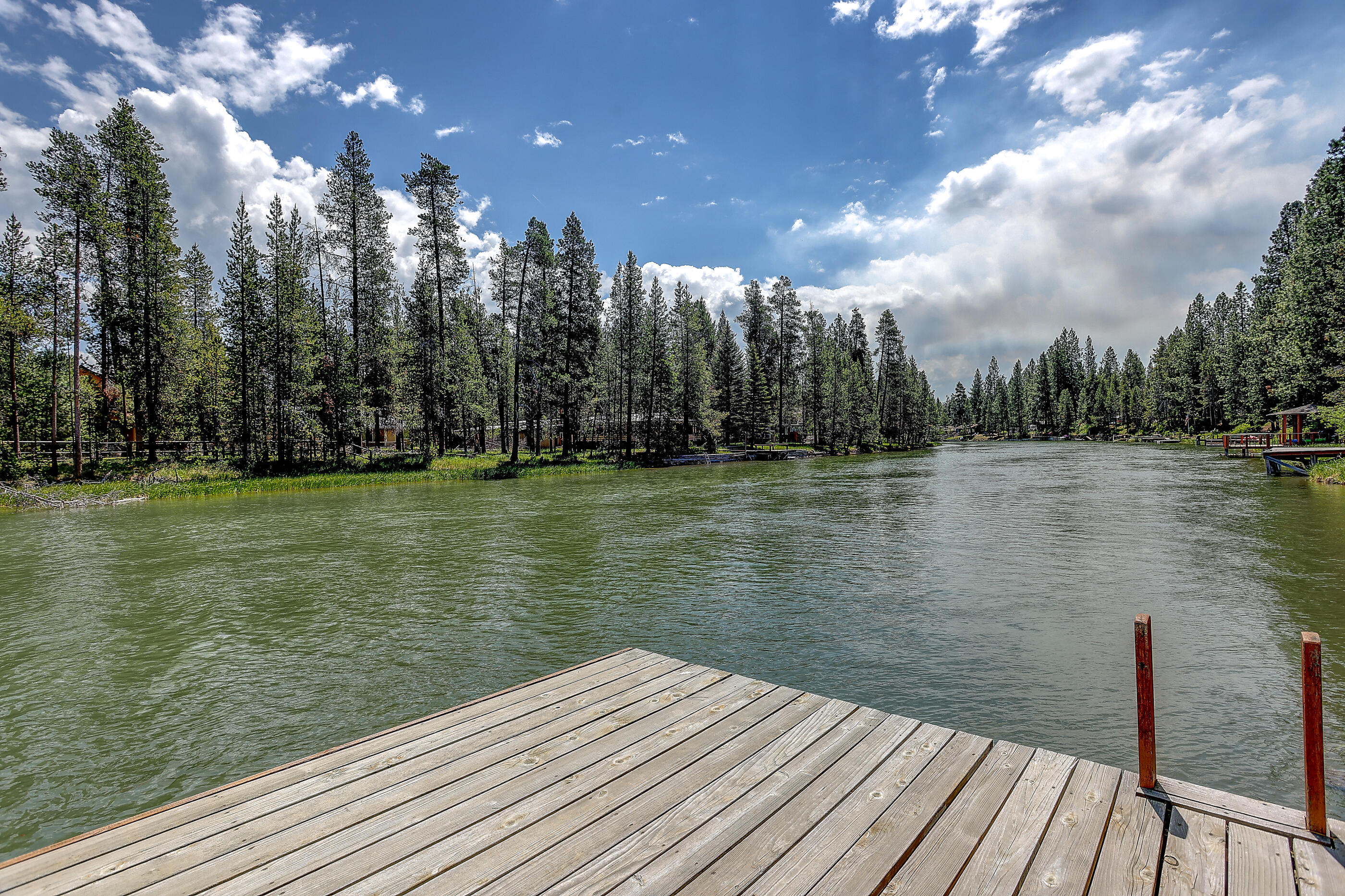Welcome to your riverside paradise on the Deschutes River! This exquisite 1,959 sqft home has been thoughtfully renovated and offers 3 beds, 3 baths, and a private dock. Surrounded by majestic old growth pine trees, you'll enjoy approximately 110' of river frontage and a large backyard with unlimited options to relax or recreate. With multiple spots to tie off and a  boat slip, you can explore and enjoy over 20 miles of the beautiful Deschutes scenic waterways right from your own backyard. Embrace the allure of riverside living in this exceptional oasis, where tranquility and adventure await.