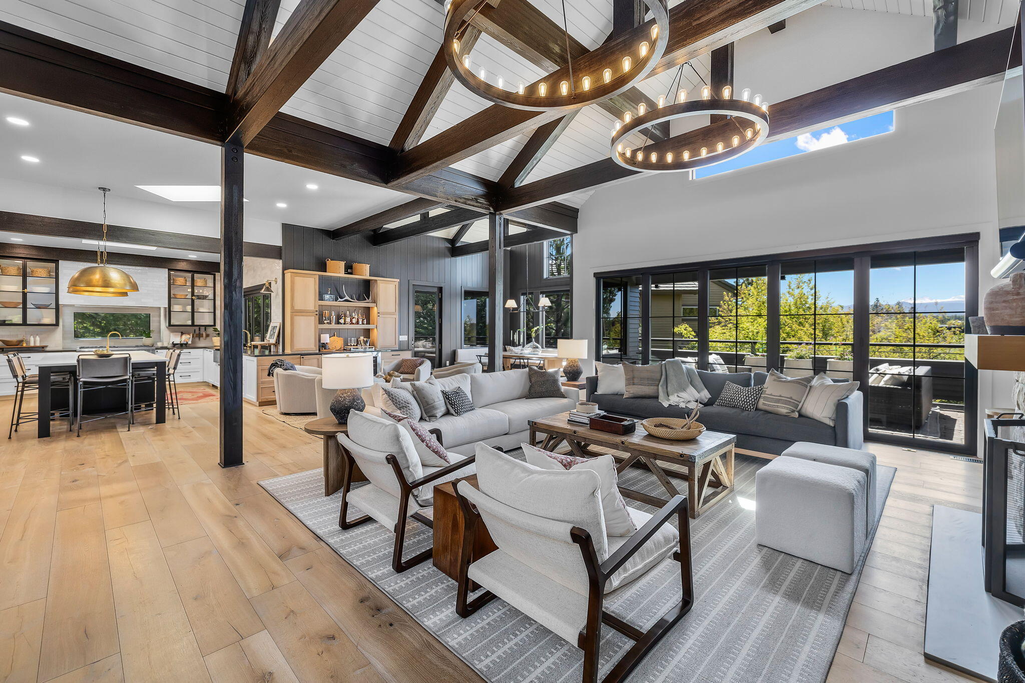 Experience luxury living at its finest in this stunning custom home with breathtaking Cascade Mountain views. Recently renovated to perfection, no detail has been overlooked in this exquisite Broken Top residence. Entertain in style in this designer showcase featuring fine craftsmanship and top-quality finishes throughout. Step into the architecturally impressive entry leading to a grand great room with cathedral ceilings and panoramic windows showcasing the awe-inspiring vistas. The gourmet kitchen is a chef's dream with Thermador appliances and an oversized island. Retreat to the sunlit master suite with a cozy fireplace, spa-like bath, and walk-in closets. Watch the sunset from the private hot tub. Downstairs, Enjoy two en-suite guest rooms with private patios, a spacious family/media room, and a spacious mudroom/laundry room for added convenience. 5th bedroom could be gym/flex room. With 3-car garage and ample storage space, this home is a true masterpiece for the discerning buyer