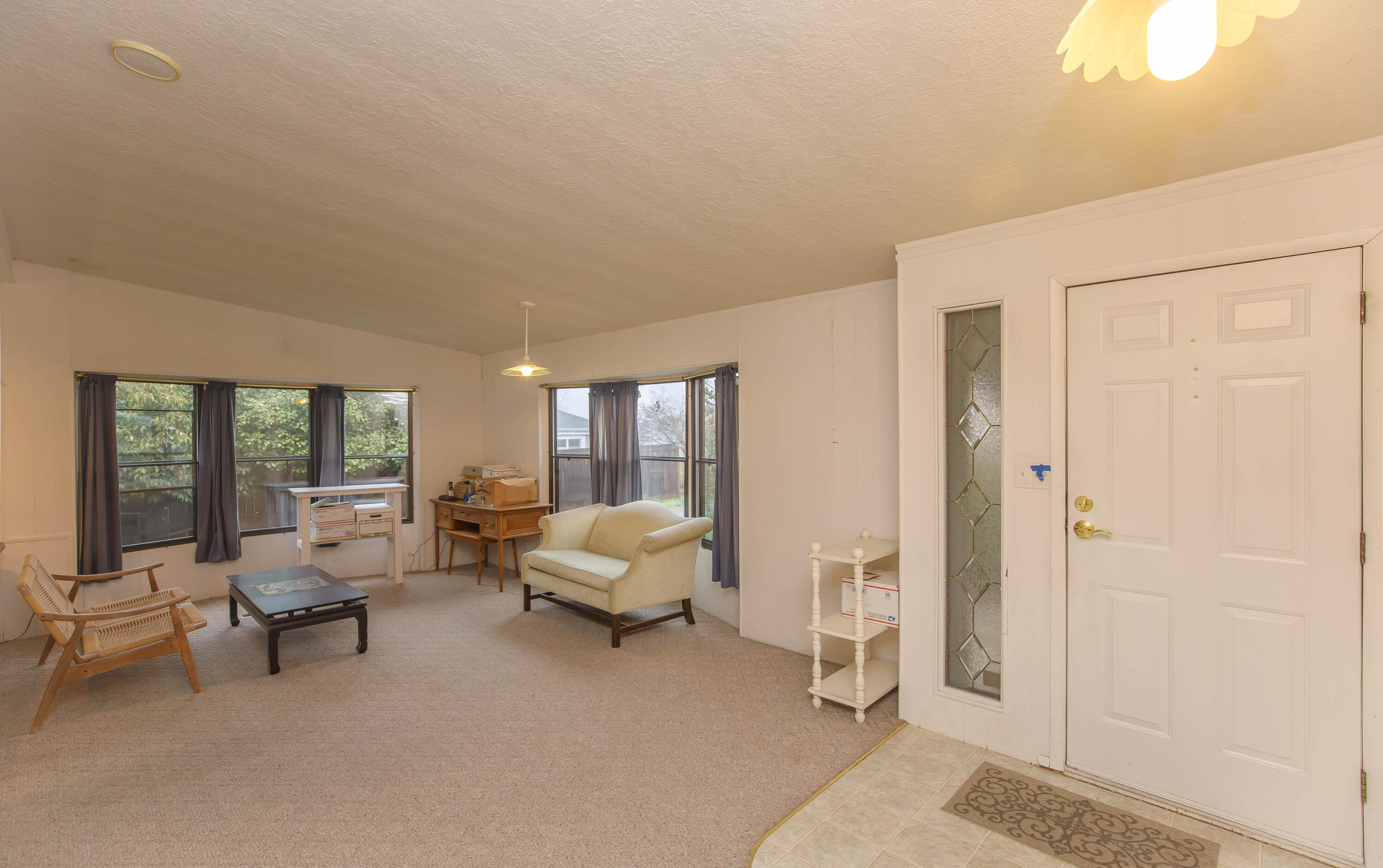 Tucked into a quiet corner of Tolman Creek Park, this light-filled 2 bedroom, 1.5-bath-manufactured home offers a rare blend of privacy & connection. The spacious living & dining area spans the entire front of the home, welcoming you with abundant natural light & an easy, open flow for everyday living or entertaining. Out back, enjoy peaceful views backing to the YMCA soccer field, serene & open, yet far from feeling isolated. Cozy up by the wood stove on cooler days or step into the screened-in back porch complete with a sink, an ideal space for a craft room, workshop, or creative retreat. Multiple storage sheds add valuable functionality, while the park itself features a lovely grassy open space, perfect for casual community get-togethers or chatting with neighbors as you pick up your mail. Guest parking is conveniently located just across the street from the driveway. Comfortable, welcoming, & well-situated, this home offers a wonderful balance of quiet living & friendly community.