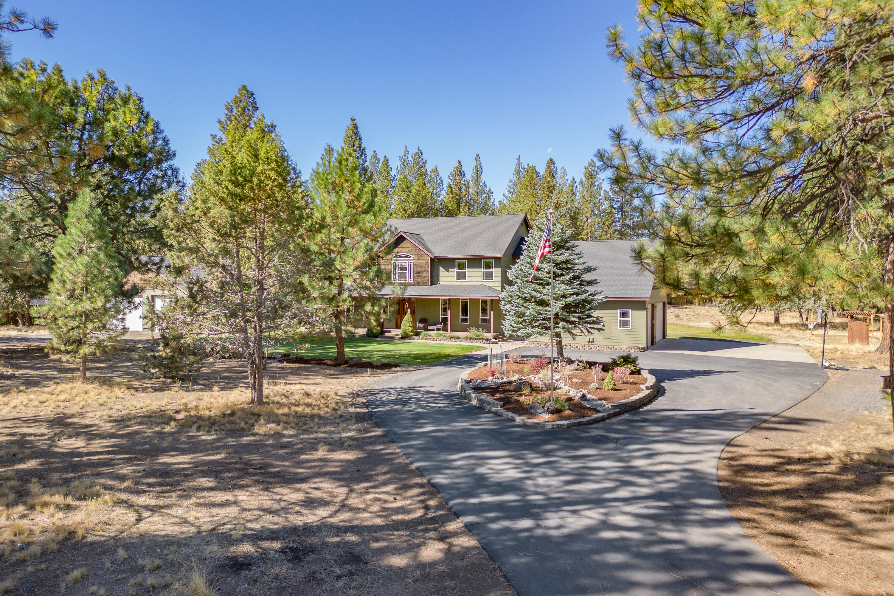 Nestled on 2.18 fenced acres just beyond the city limits in SW Bend, this spacious home offers a little slice of country living with an abundance of space inside and out. The interior features 4 bedrooms, 2 full and 2 half bathrooms, as well as a roomy bonus space over the attached 3-car garage. The first floor boasts a home office set just off the entry, a cozy family room, a well-equipped kitchen with a breakfast nook, a dedicated dining room, and a welcoming living room. Outdoors, a 1440 sq ft detached three-bay shop offers endless possibilities with oversized 10 ft tall doors and loads of storage space. A chicken coop, paved driveway, expansive deck off the rear of the home, a covered front porch, and towering pine trees blend to create an idyllic small acreage retreat located just minutes from shopping, schools, trails, parks, and the thriving Old Mill District.