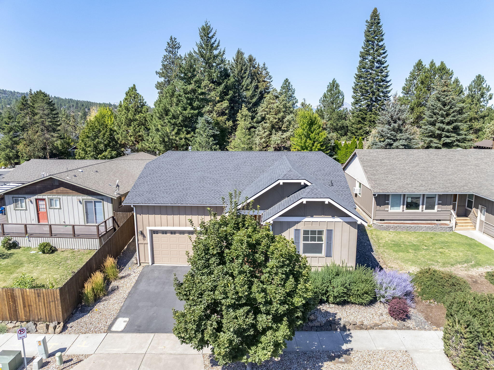 Built in 2005 by Palmer Homes, this charming single-level bungalow offers 3 bedrooms and 2 baths in a thoughtfully designed floor plan. The light-filled great room features hardwood floors, custom built-ins, and a cozy gas fireplace—perfect for gatherings or quiet evenings at home. The spacious primary suite is set apart for privacy, while generous storage and a huge garage add everyday convenience. The fully fenced backyard, shaded by mature trees, is ready for your personal touch. Located in the sought-after Westerly neighborhood, you'll enjoy Harvest Park's play area and trails, plus unbeatable access to shopping, dining, and all that Bend has to offer. Move-in ready and waiting to welcome you home.