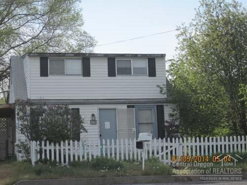 This little home in SW Madras has some great updates! 2 bedrooms on 2nd floor have new carpet and the 2nd floor bathroom has been updated. Main level has living room with new carpet, kitchen and bathroom. Covered patio in rear accessed by glass doors. Small storage shed. Exterior needs a little TLC.