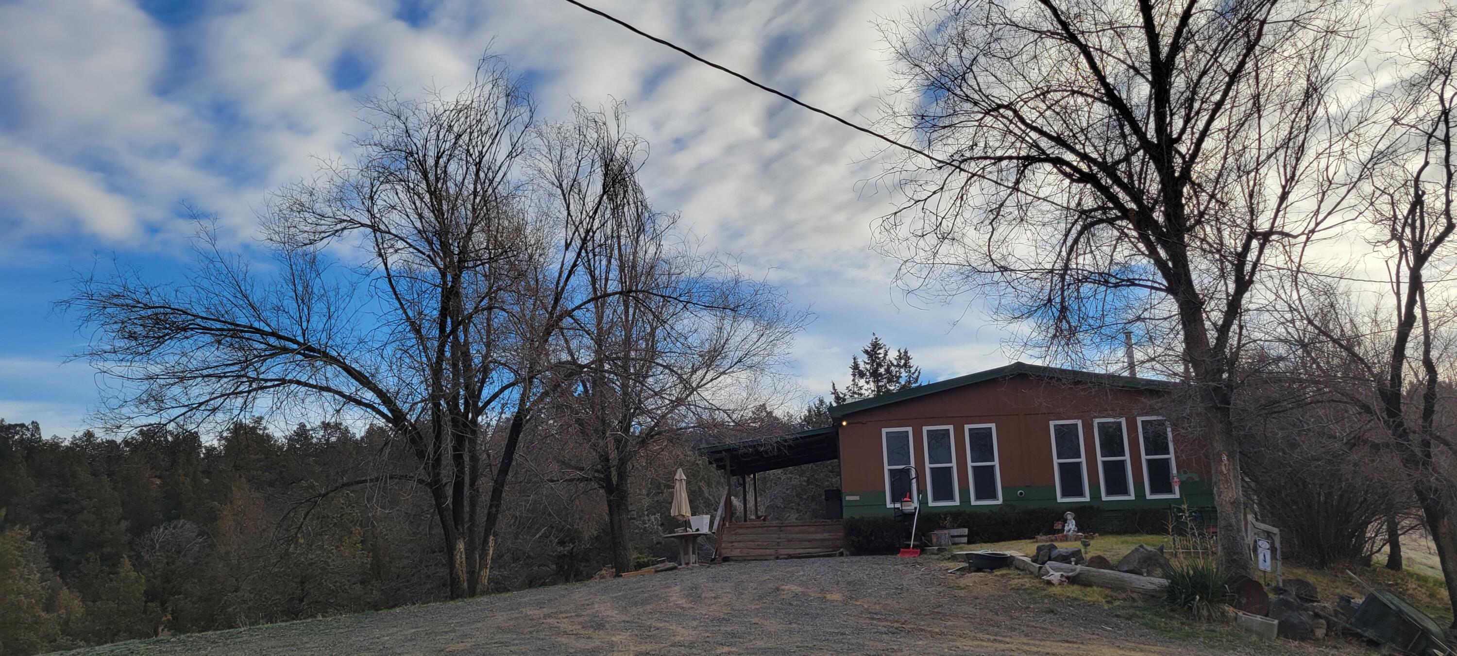 Cozy country home on 7.34 acres with beautiful Lost River views. This 1,782 sq. ft., 3 bed / 2.5 bath manufactured home offers a spacious layout and peaceful rural setting. Plenty of room to expand, create a hobby farm, or enjoy the open land and privacy. A perfect blend of comfort, space, and scenic surroundings with a great barn for horses or 4-H animals!
