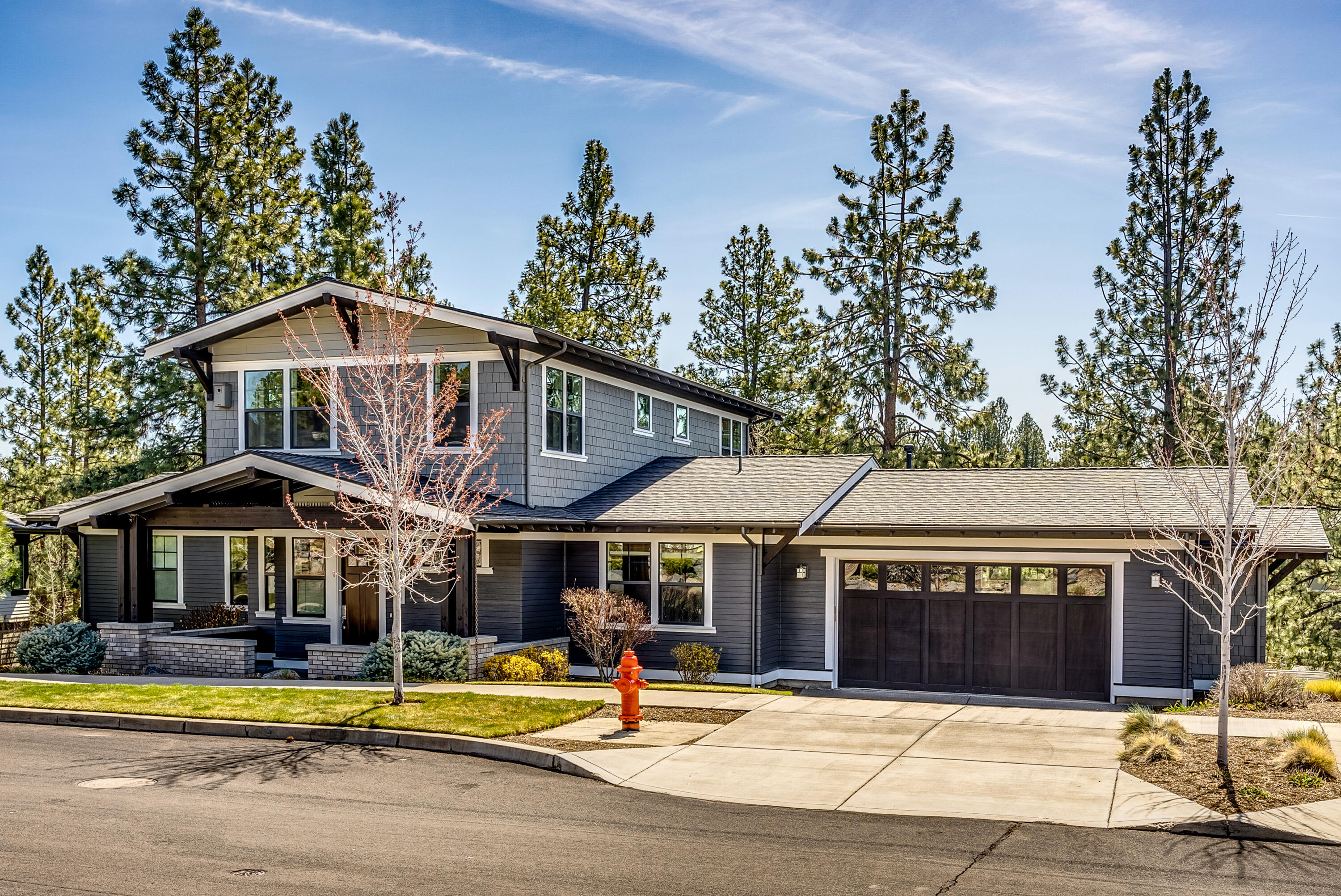 This beautiful contemporary Craftsman home in Northwest Crossing has it all-open great room, kitchen, and dining area with hardwood floors, quartz counters, wood cabinets, large pantry and island. Primary bedroom and large bathroom with walk in shower are on the main floor with its own private balcony overlooking the backyard. Laundry room and spare bedroom with full bath attached on the main floor as well. Stunning built in cabinetry throughout home. High ceilings and large windows abound. Upstairs you will find an expansive bonus room with vaulted ceiling, bedroom and bathroom and an office complete with custom cabinets (4th bedroom). Yard is fully
landscaped with covered deck, large paver patios and stone stairway down to the fenced backyard complete with artificial turf and a water feature. Home has been recently painted inside and out. Enjoy all that Central Oregon has to offer from this spectacular home!