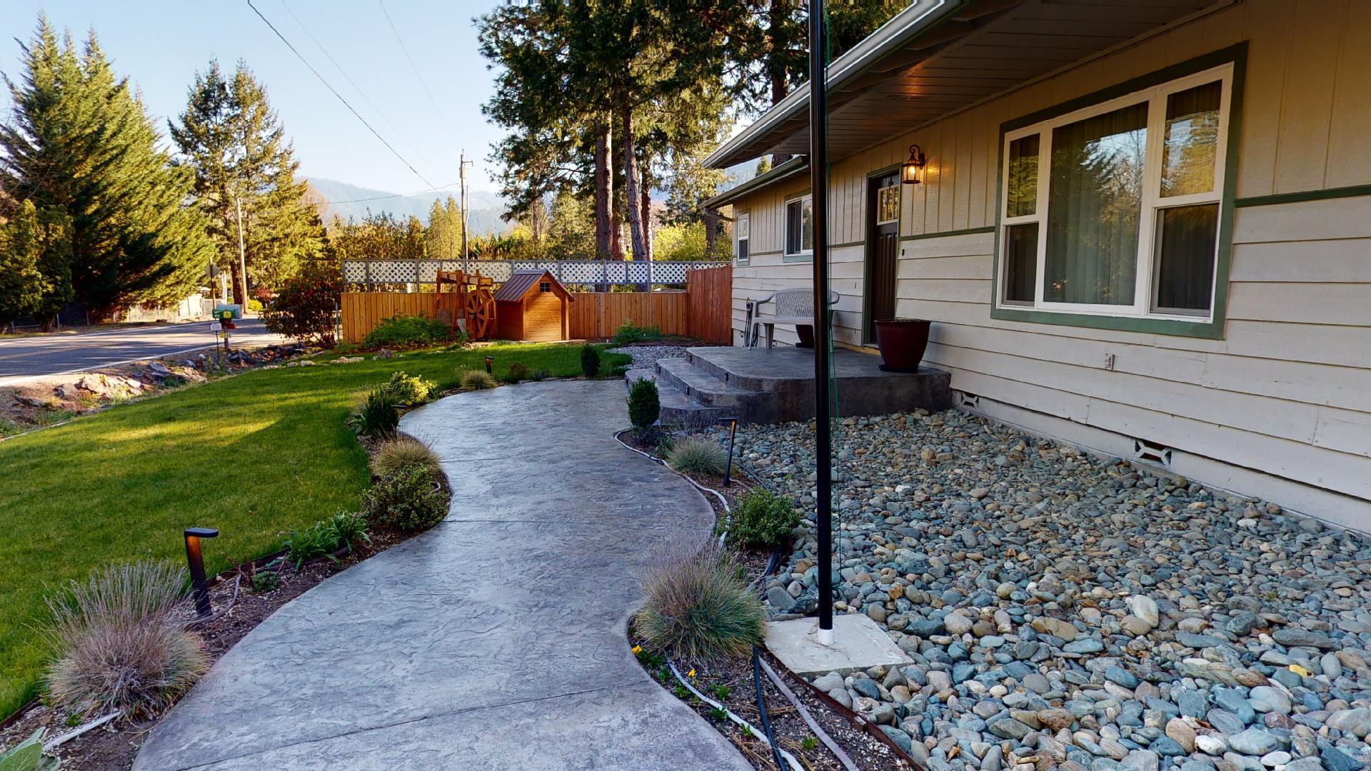 Lovely Ranch Style home with a Very Park Like Setting. This 3 bedroom, 3 bath home rests on .51 of an acre, and offers 1760 sq ft. In addition to the 2 en suites, this home has an amazing covered back patio, that opens up to a gorgeous back lawn, flower beds, raised garden beds, and some magnificent pine trees. This home has been updated with stainless steel appliances, and has large windows for great natural light, and a generous amount of kitchen storage. Take advantage of this over sized drive through garage (10 Ft tall), and convenient location. Turn key home, ready for new owners.
