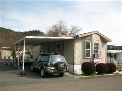 Wonderful Spacious Home in 55+ park, close to Post Office & Grocery Store. The home is handicap accessible with a ramp & handrails. Home is light & bright with vaulted ceilings; newer dishwasher, refrigerator and water heater. Kitchen has eating area plus snack bar. The big bathroom has a 60 shower with seats. Nice covered deck to enjoy the summer and a big storage shed. Rear yard is fenced for small pet.