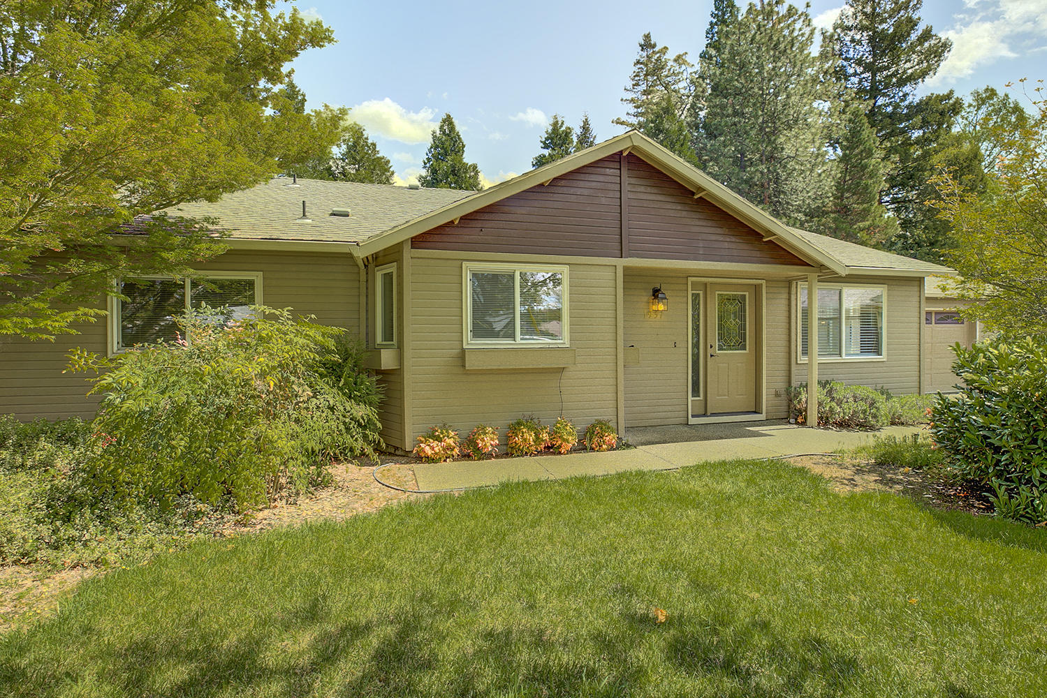 Charming updated home in a great location.  Move – in ready, meticulously maintained 1756 square feet, 3 bedroom, 2 bath, located at the end of a cul-de-sac on a quiet, tree lined street.  Updated wood flooring in kitchen and living rooms with vaulted ceilings.  Kitchen offers extra-large pantry, and double door refrigerator with water and ice.  Open concept, split floor plan is perfect for entertaining.  Large private master suite offers walk-in closet and en-suite bath includes a tub.  Glass doors open onto peaceful backyard garden and patio.  Patio is wired for a hot tub.  Beautiful mountain views from backyard and master bedroom.  Professionally landscaped yard has automatic irrigation system installed.  Attached two car garage includes a work bench and cabinets, additional parking with room for an RV or boat.  Located in the Griffin Creek school district.