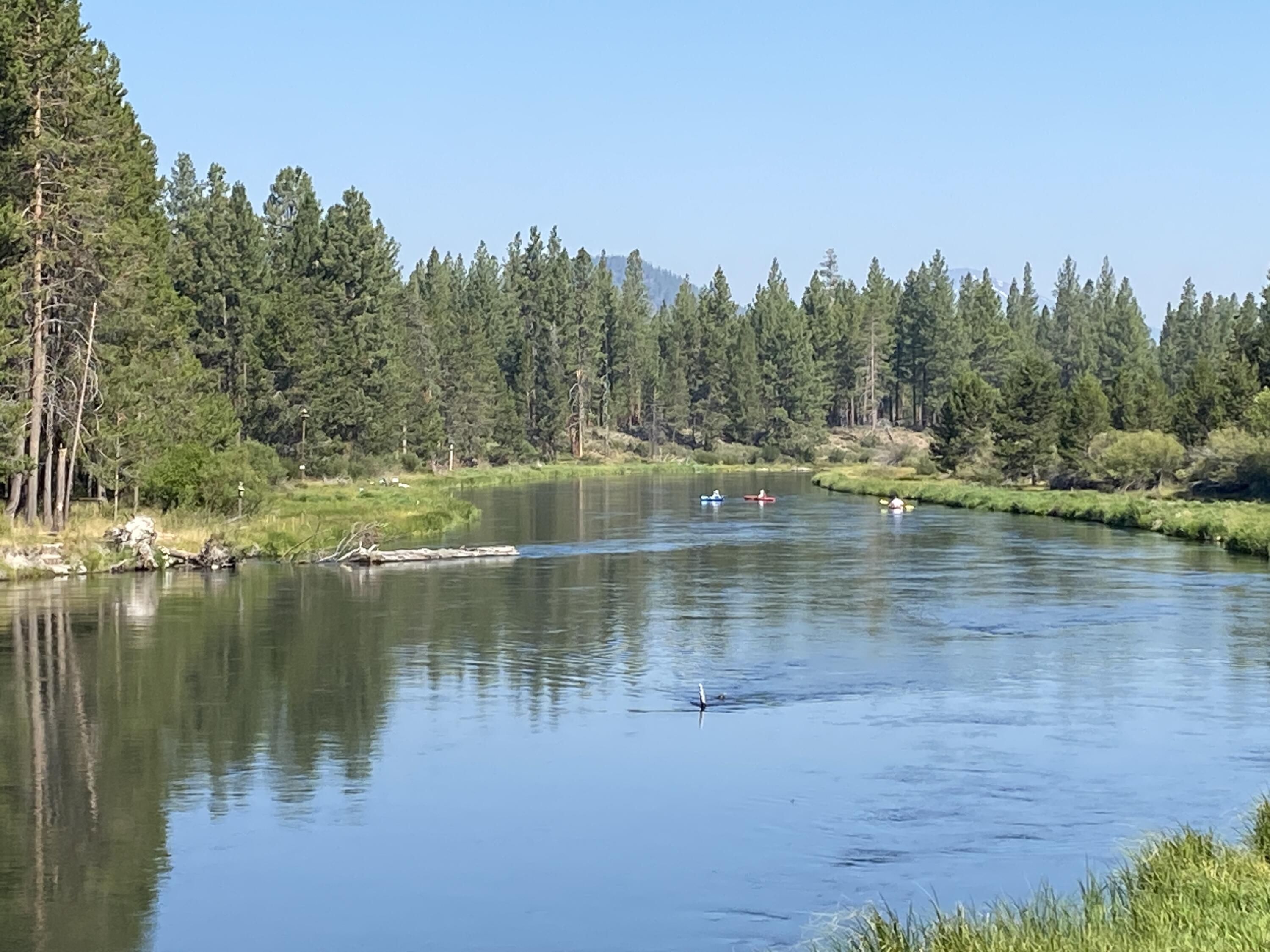 This beautiful riverfront home is the ultimate haven for engaging with nature. Paddle or kayak the big Deschutes River, and hike, bike, snow shoe & cross country ski through miles of state park trails right out your door. Immerse yourself in relaxation on the deck, where the symphony of the river merges with vistas safeguarded from future construction. Inside, the remodeled kitchen leads to the lofty great room adorned with a gas fireplace and grand windows framing the river panorama. Upstairs, the primary suite enjoys a cozy fireplace and elevated view, luxurious soaking tub and double vanity. 2 additional guest rooms share a full bath. The lower level is a spacious bonus room that spills onto its own deck with easy access to the storage shed. Enjoy the purity of a new water filtration system and a carport for your boat or camper. With easy access to Mt. Bachelor & Sunriver, unleash the potential of short-term rentals, or simply enjoy this enchanting home & setting all to yourself.