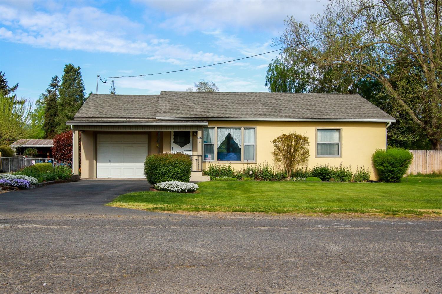 First time on the market! This wonderful home on an over sized lot is as cute as a button. Enjoy the close proximity to Jacksonville and Medford while still in a country setting. Newer roof, water heater and furnace. Don't miss the well preserved Oak hardwood floors under the carpets as well. Lot continues to the furthest back fence behind fenced backyard and barn.