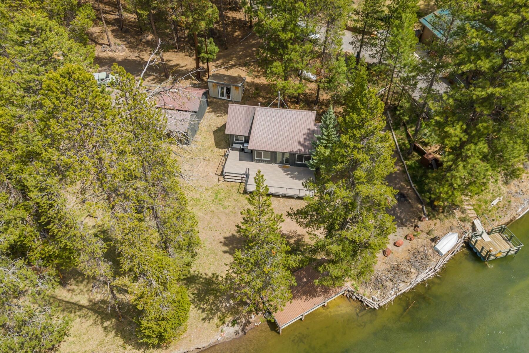 Updated riverfront Cabin in the sought after Haner Park community. 110 beautiful feet of river frontage, on a spacious and private 0.78-acre lot with its own private dock! This gem can be sold mostly furnished and is ready to be used as your next vacation retreat. New large front Trex deck, a large storage shed, and an additional finished building that could be used for extra storage or more living space. Step out your front door to fly fish, or head out on your kayak for a serene river float. Surrounded by great trails for cross country skiing and snowmobiling in the winter! This is your perfect all season vacation cabin!