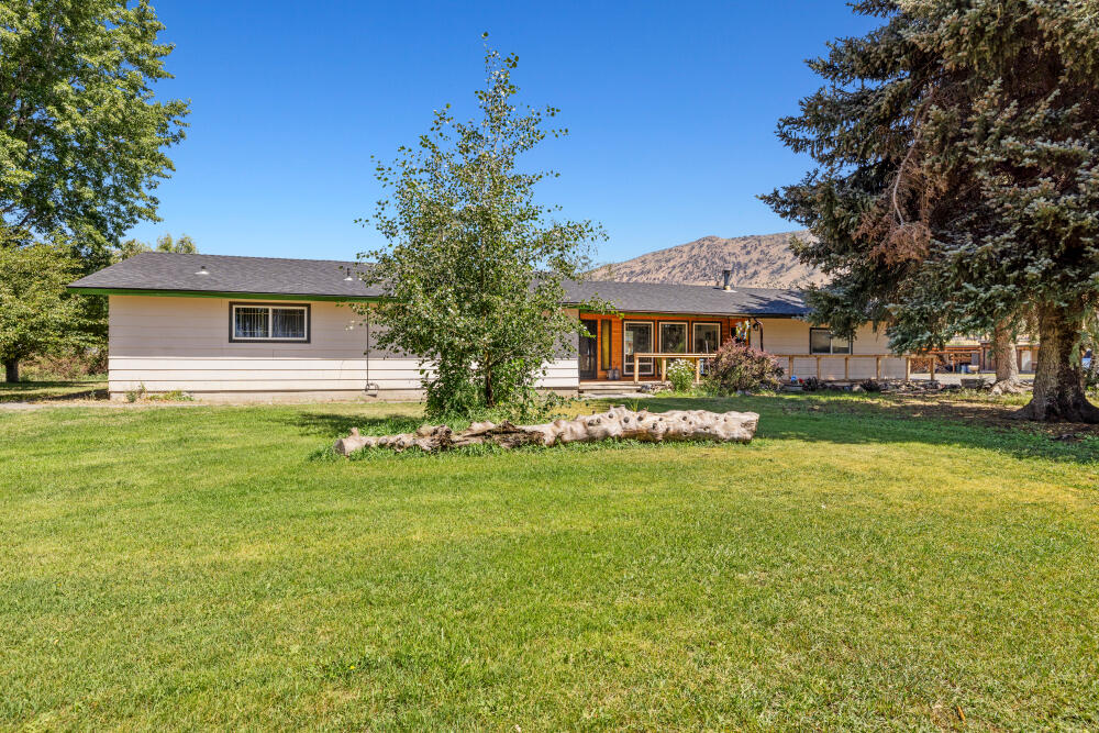 Make this haven on the Lost River your home! Allow cool afternoon breezes to whisk you away to a peaceful retreat on this 4.30-acre hobby farm. Big shade trees, beautiful flower gardens and the perfect little greenhouse are just the start of this must-see property. The large +/-50'X46' shop was built to accommodate log trucks and boasts a reinforced 3' deep concrete slab. Unique to this property, KID irrigation rights for 3.51 acres are at the end of the ditch and allow for maximum usage.441' of river frontage allow you year-round access for fishing,swimming,kataking,etc.Inside the home,enjoy oversized picture windows w/ custom tongue & groove finishes in the family room,a cozy certified woodstove,newer roof & tons of potential to make the space exactly what you want. Attached 2 car garage.Plenty of trailer or RV parking w/ 50amp hook ups, 6 frost free hydrants on 1.5HP pump, raised garden beds and chicken coop top off this desirable property.