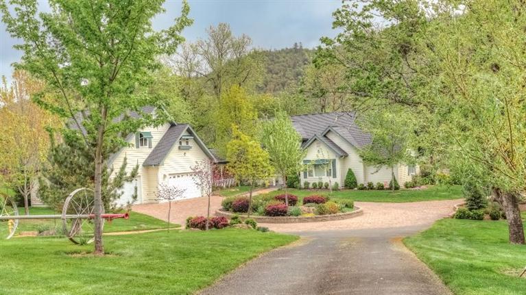 Captivating views bring the outdoors in on this beautifully treed 3.1 ac. w/256' of premier Rogue River frontage. Enjoy living on your own private sanctuary w/over 1/3 mi. walking paths, fruit trees, herb garden, circular driveway & huge R.V. parking w/hookups. One of the most stunning homes in the valley w/unparalleled quality, master craftsmanship & brilliant use of architectural design & detail throughout. Expansive floor to ceiling windows & 20' vaulted ceilings, hardwood floors, w/gas fireplace in the open living/dining area. Large mstr.suite w/pedestal bathtub, his/her vanity's, huge walk-in shower,& private river-view deck. Kitchen is a designers dream, beautiful cabinetry, gorgeous granite, Heartland vintage refrigerator and gas stove/cook top. Wonderful loft area w/2 suites upstairs. Beautiful artists studio or office. w/Waterford wood-stove above the 3 car gar.Separate river front tax lot 1.44 ac. included
