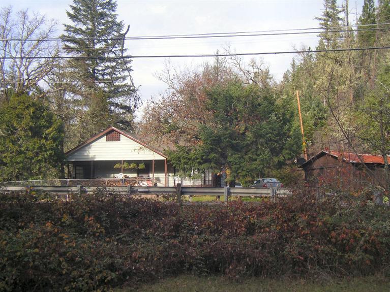 A fantastic buy. There are 4-tax lots including one very nice half acre Rogue River front parcel. You also have Lewis Creek running down through the property. The 1,300 sq. ft. home has a nice 8x28-ft front porch which is facing toward the Rogue River. The home does need updating and TLC. There is a single car garage with shop area. A covered RV parking area of approximately 18x40-feet and at least 3-other outbuildings for your use. This is a great buy at this price.
