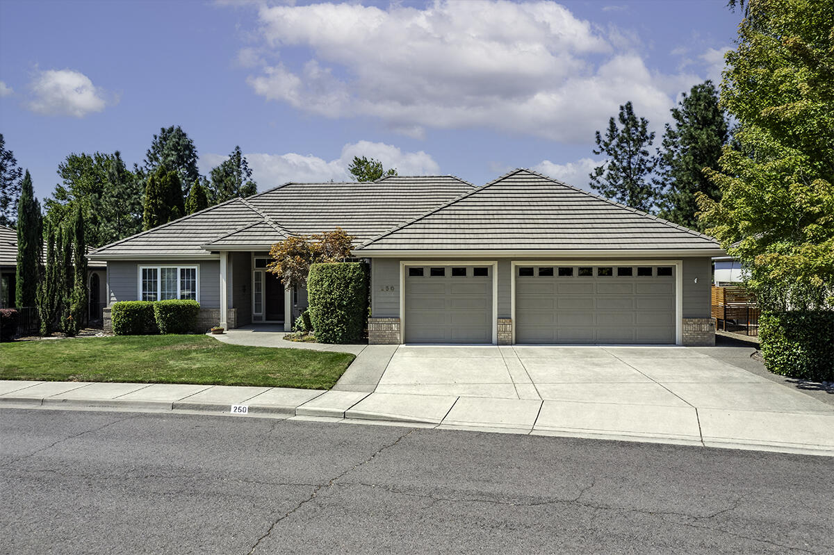 Stunning, contemporary single level 3 bed, 3 bath home perfectly positioned on the Rogue Valley Country Club! Walls of windows frame expansive, unobstructed views of the 8th fairway, filling the space w/abundant natural light. The split bedroom, open concept layout boasts clean lines, high end finishes & a continuous flow between the living, dining & kitchen areas - ideal for both everyday living & entertaining. Luxurious primary suite featuring a large walk-in closet, private patio access & spacious ensuite w/two vanities, a jetted tub, tile shower & private water closet. Gourmet kitchen equipped w/an oversized island, granite countertops, double ovens, appliance garage & gas cooktop. Additional features include hardwood floors, gas fireplace w/granite surround & mantle plus a dedicated laundry/mud room w/built-in cabinetry, work area & utility sink. 3-car garage, tile roof & mature, easy-care landscaping with a spacious covered patio & convenient remote-controlled sunshade.