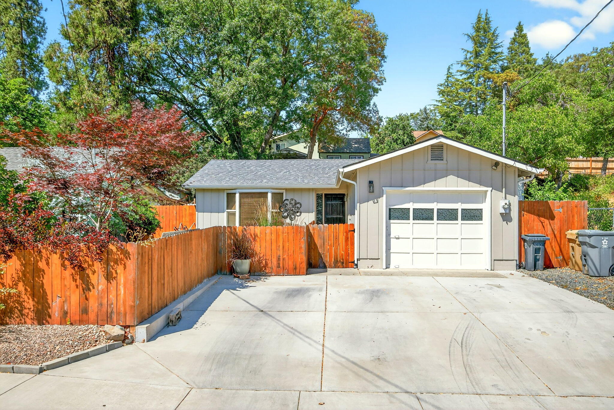 This well-kept home is nestled in a quiet neighborhood, just moments from schools, parks, and the Grants Pass downtown area. With a fenced backyard and tasteful landscaping, the space feels private and relaxed, a rare ''best of both worlds'' when coupled with its in-town location. The seller has completed many upgrades to include cabinetry, appliances, flooring, and paint. The living area offers high ceilings and plenty of natural light, creating a cozy but roomy atmosphere. The extra-wide driveway provides room for multiple cars, or even an RV or a boat. So whether you're buying your first home, looking for an investment property, downsizing, or anything else in between, this home is move-in ready and full of potential. Schedule your viewing appointment today!