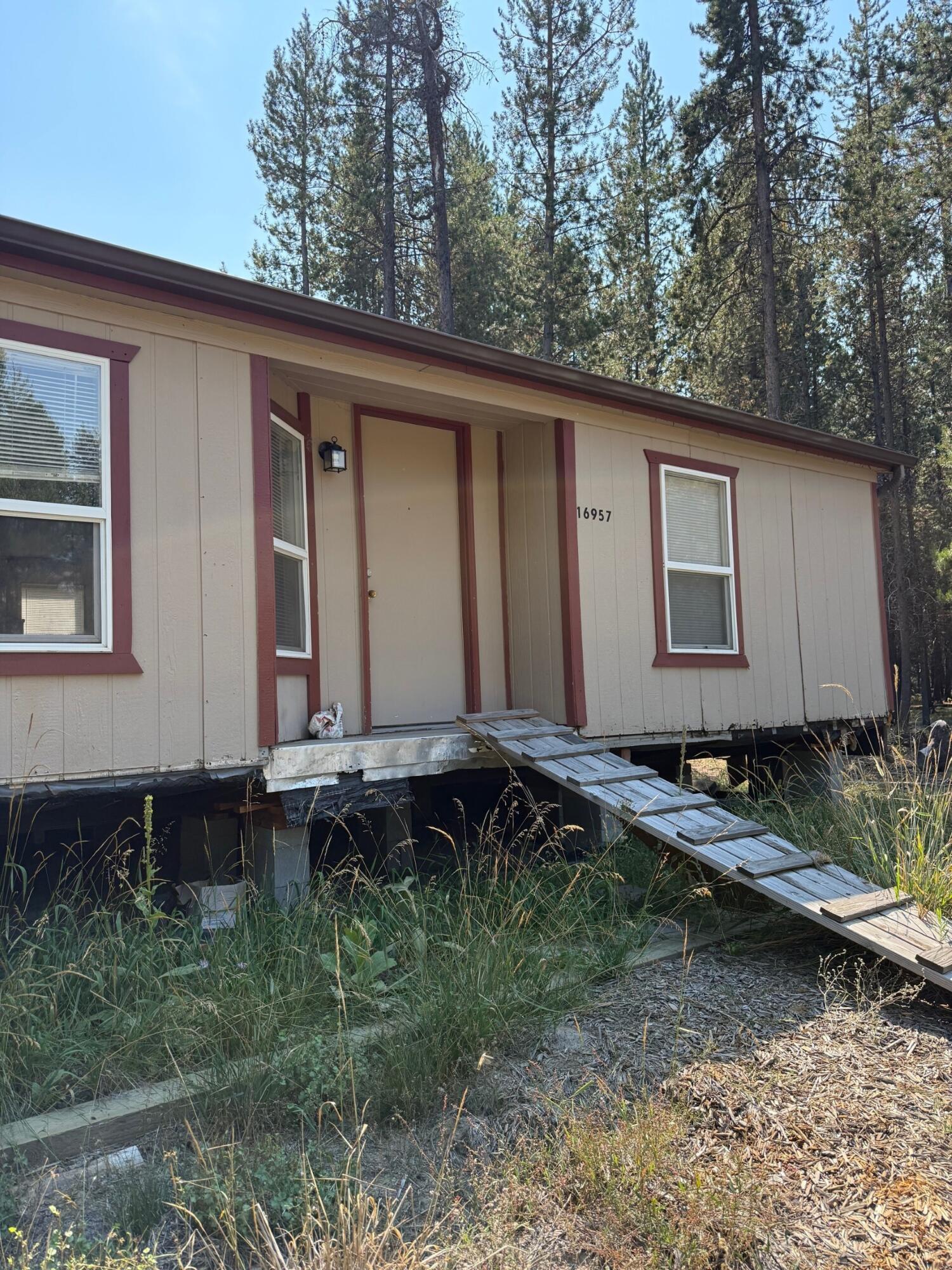 Affordable property with utilities in place! Looking for a great deal or investment property? This property features an older manufactured home that needs remodeling, giving you the perfect chance to create a home that fits your style and budget. Well and power are already installed, saving you thousands in setup costs. No septic system yet, allowing you to design your own. With some work, this vacant go show, lock box on porch could be a fantastic affordable living option or a cozy getaway. Priced to sell as-is, so bring your tools and imagination! Lot adjacent to property also for sale for a more spacious option to new home owner. Property's location is situated just down the road from the National Forest at the base of Ann's Butte.