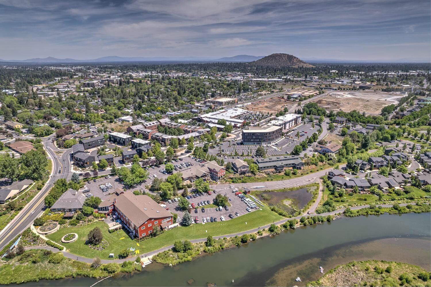 Experience the ultimate urban lifestyle at Basecamp: Bend's sought-after community of modern townhomes featuring stunning architectural design and an outdoor enthusiast's dream location. Situated in the heart of Bend just one block to the Deschutes River & steps to the Old Mill District & all Downtown amenities, this thoughtfully-designed END UNIT offers 3BR/3BA PLUS a legal 1BR/1BA ADU. Exquisite light-filled Great Rm w/floor-to-ceiling windows, warm wood accents & access to covered deck. Chef's Kitchen offers Quartz countertops, extensive working isl, sleek subway backsplash, & stainless appl. Dining area, 2nd sitting rm & full BA on main. Upstairs: Primary Suite w/walk-in closet & spa-like BA w/dual vanity & tiled shower. 2 additional BR + full BA & loft flex space. Ground level ADU w/separate entrance is an excellent income generator or fantastic home office space. 2 car attached garage for all your Bend gear. Delightful community grill, fire pit & common area to enjoy year-round.