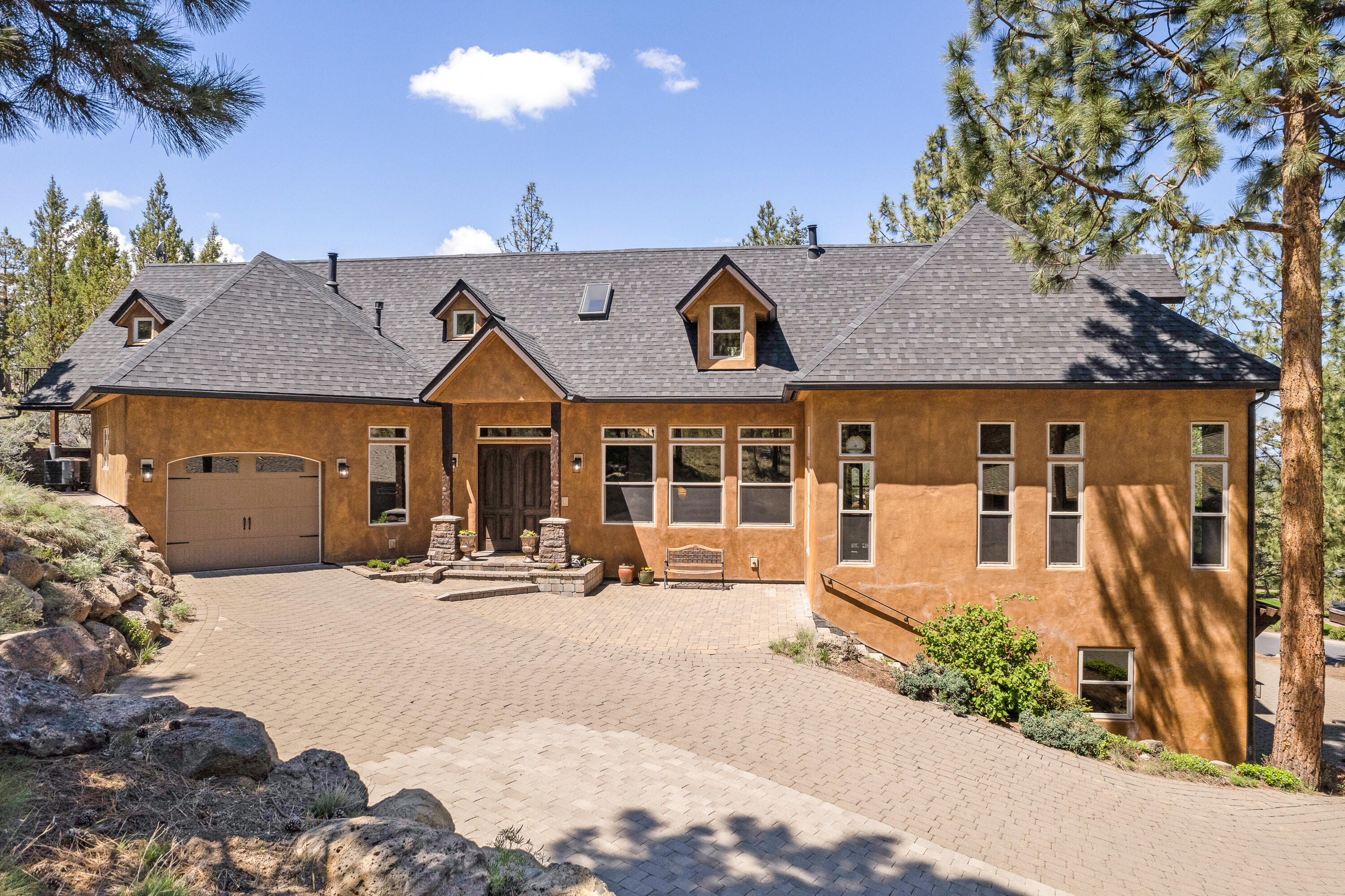Introducing a stunning Italian-inspired masterpiece with captivating Cascade Mountain views. This 4 BD, 4.5 BA custom home spans 4,785 SF & features high-end finishes throughout. Enter to 13-14' ceilings, 8 ½' doors, elegant exposed beams, custom ironworks & 3 cast stone fireplaces. The entire home boasts custom tile travertine floors & baths, showcasing exquisite craftsmanship & attention to detail. The chef's kitchen incl's SS appl., granite counters & ample storage. The main level offers lovely decks overlooking mtns & forest (perfect for entertaining), along with the serene Primary Suite w/ stunning spa like bath & 2 walk in closets. Upstairs offers an addt'l en suite, spacious loft, bonus & BD. Enjoy the grand living room w/ floor-to-ceiling windows & views. Additionally, the lower level offers a 1,500-bottle mahogany wine cellar, a spacious garage, new roof, carpet & more.  Serene privacy completes this Italian-inspired gem. Immerse yourself in luxury, comfort & natural beauty.