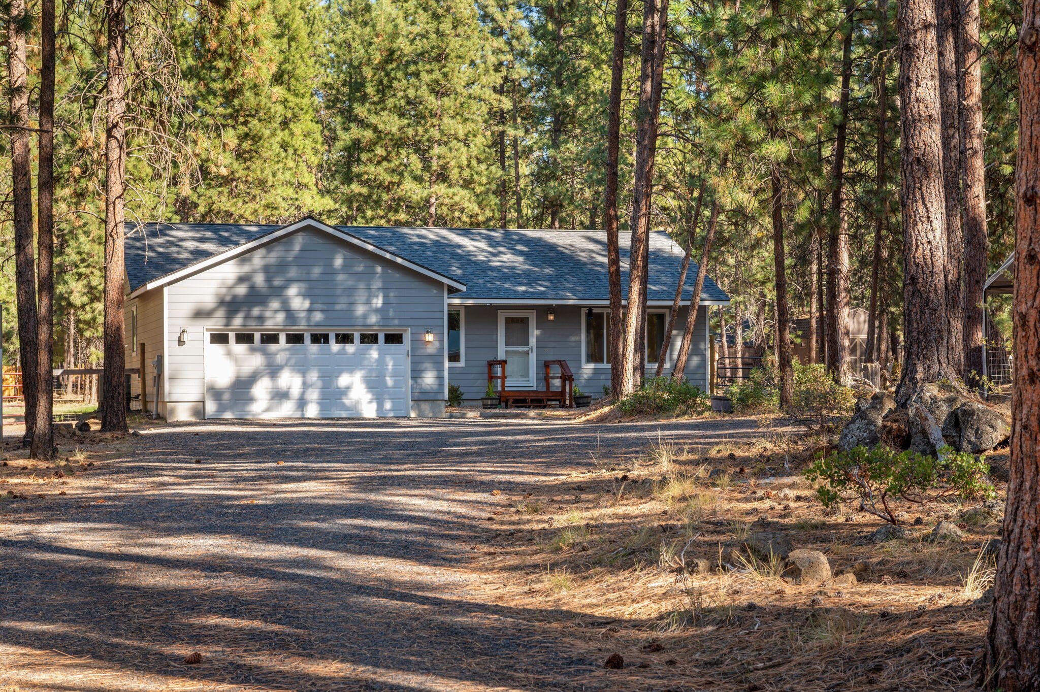 Nearly new single-level home on 1.26 acres! Built in 2019, this thoughtfully designed 3-bedroom, 2-bath home features a bright, open great-room floor plan with vaulted ceilings and abundant natural light. The spacious kitchen and living area flow seamlessly to the large Trex deck—perfect for entertaining or relaxing in the private, fully fenced backyard. The primary suite offers a generous walk-in closet and dual-sink vanity. Ample storage throughout includes a pantry, coat closet, and two linen closets—plus two large storage sheds and a roomy two-car garage with high ceilings. A convenient hot/cold outdoor spigot is ideal for dog washing or gear cleanup. Enjoy peaceful country living with modern comfort, just minutes from town.