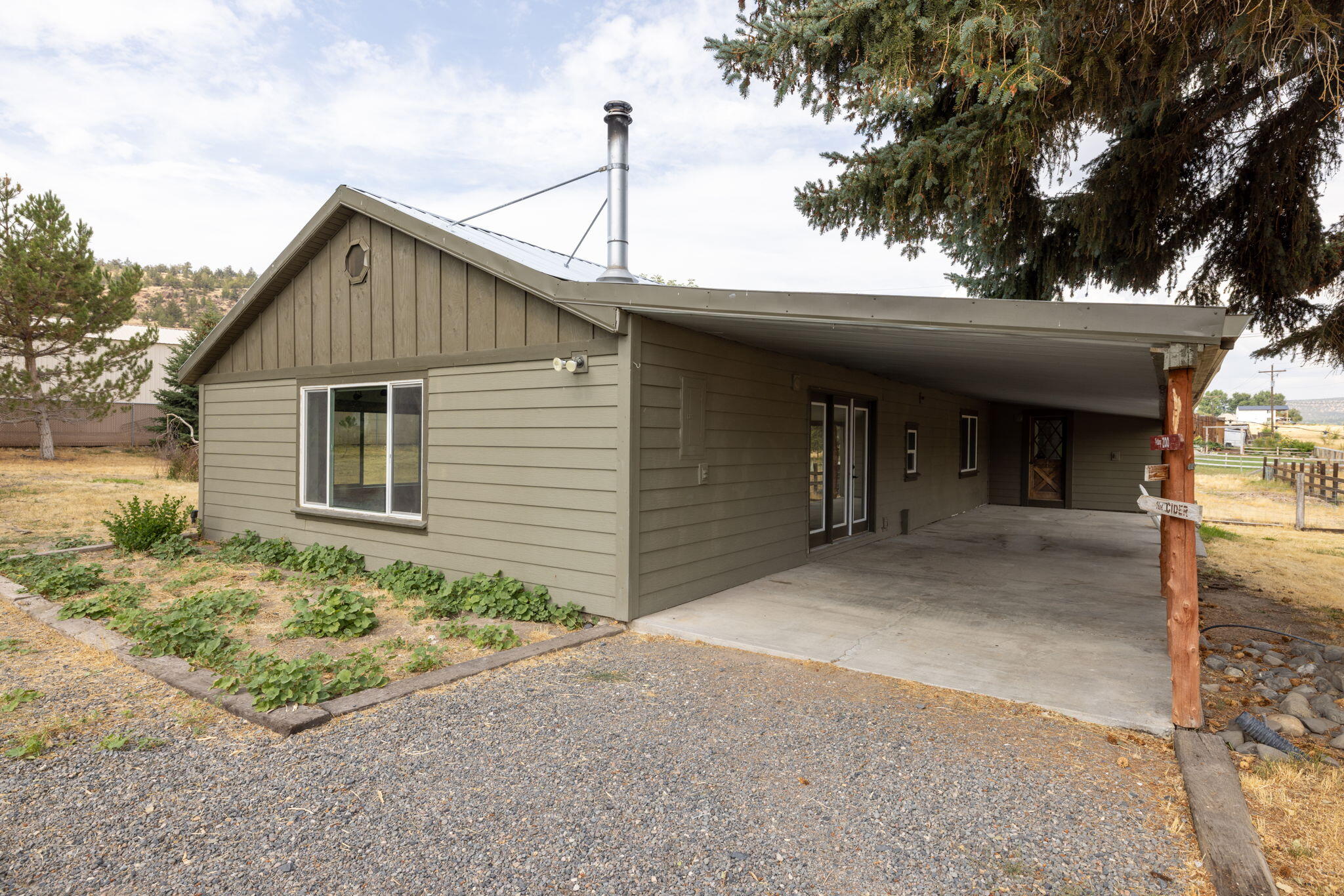 Welcome to this single-story property located on 1.04 acres, offering a unique blend of privacy and convenience just five minutes from Prineville. This 3-bedroom, 2-bath home provides ample living space characterized by a thoughtful layout and mature landscaping, creating an inviting atmosphere.  As you approach the home, you'll appreciate the private driveway, with serene farmland on the east side, providing a peaceful backdrop and beautiful views. The exterior features well-maintained grounds, ensuring a welcoming first impression. The property includes a large shop equipped with a loft for additional storage. This versatile space features a separate room, perfect for various uses—be it a workshop, storage area, or a hobby space. Beyond the shop, the fenced irrigated pasture is ideal for those interested in keeping animals or simply enjoying the open space for recreational activities. Additionally, there's ample room for RV/toy parking, catering to a variety of lifestyles.