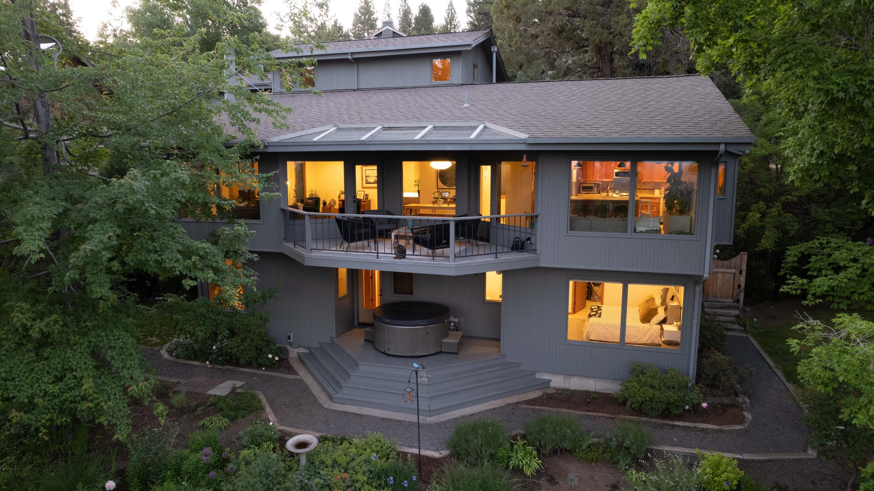 A true Mid Century Modern beauty in NW Bend! Enjoy sweeping views of downtown Bend, Old Mill District including the iconic smoke stacks and the amphitheater. This custom built home was designed into the side of the hill, utilizing every aspect of the natural terrain to enhance efficiency in the home. With the 3 bedrooms on the lower level staying cool in summer and warm in winter. Recent updates include all new hardwood flooring, remodeled bathrooms, interior paint, new light fixtures, new electrical (EV charging station) and much more. The great room is the show stopper with vaulted wood ceilings and a wall of windows that lets the light in. The chef's kitchen has a large center island, two sinks, induction cooktop, custom pantry and tons of storage. In addition to 3 bedrooms, there's a bonus room and den/office.  The well designed double garage is extra wide/deep, with a utility sink, built in workshop cabinets & storage. The fully fenced backyard looks like your own park.