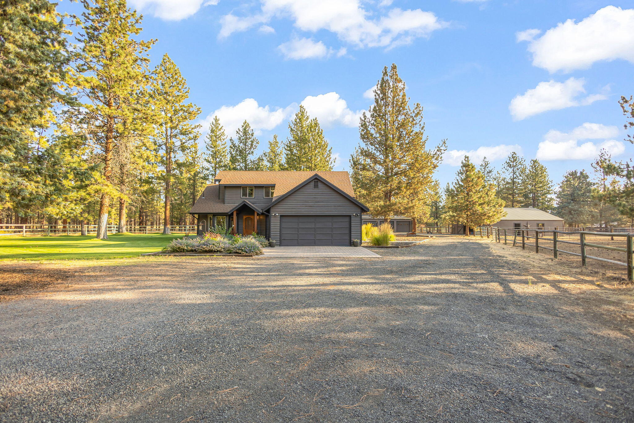 Turnkey Equestrian set up on very private acreage with direct access to USFS land and trails that is also very close to town. This horse property is perfect for equine enthusiasts: 4 stall barn with cement aisle, individual paddocks for each stall, metal roof, tack room, hay storage, feed room, good lighting, and easy access to the home and property, extensive fencing (entire property) and gates. Also includes a well laid out, and structurally sound home with high vaulted tongue and groove ceilings; a primary suite with vaulted ceilings on the main level; New HVAC with zoned mini split system and new propane woodstove. Property additionally features: Large paver patio/gazebo in backyard with complete privacy visually; Hot tub on rear patio; 3 bay shop with metal siding, metal roof, concrete floor; Greenhouse with hydraulic lifting windows; Garden/landscape shed that would make an ideal chicken coop; Extensive front and back landscape; Freshly painted/matching structures on property.